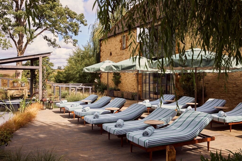 Striped loungers beside the buildings at Soho Farmhouse