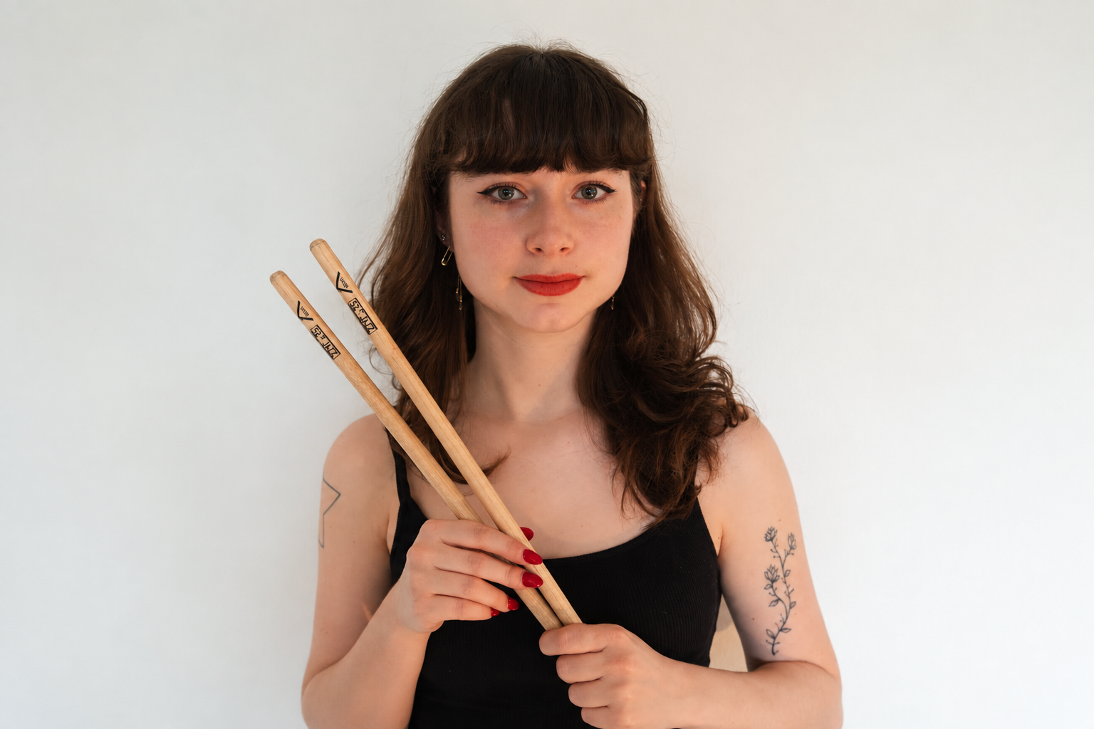 Ruby Laks holding drumsticks, in the portrait supplied by Tilles Center