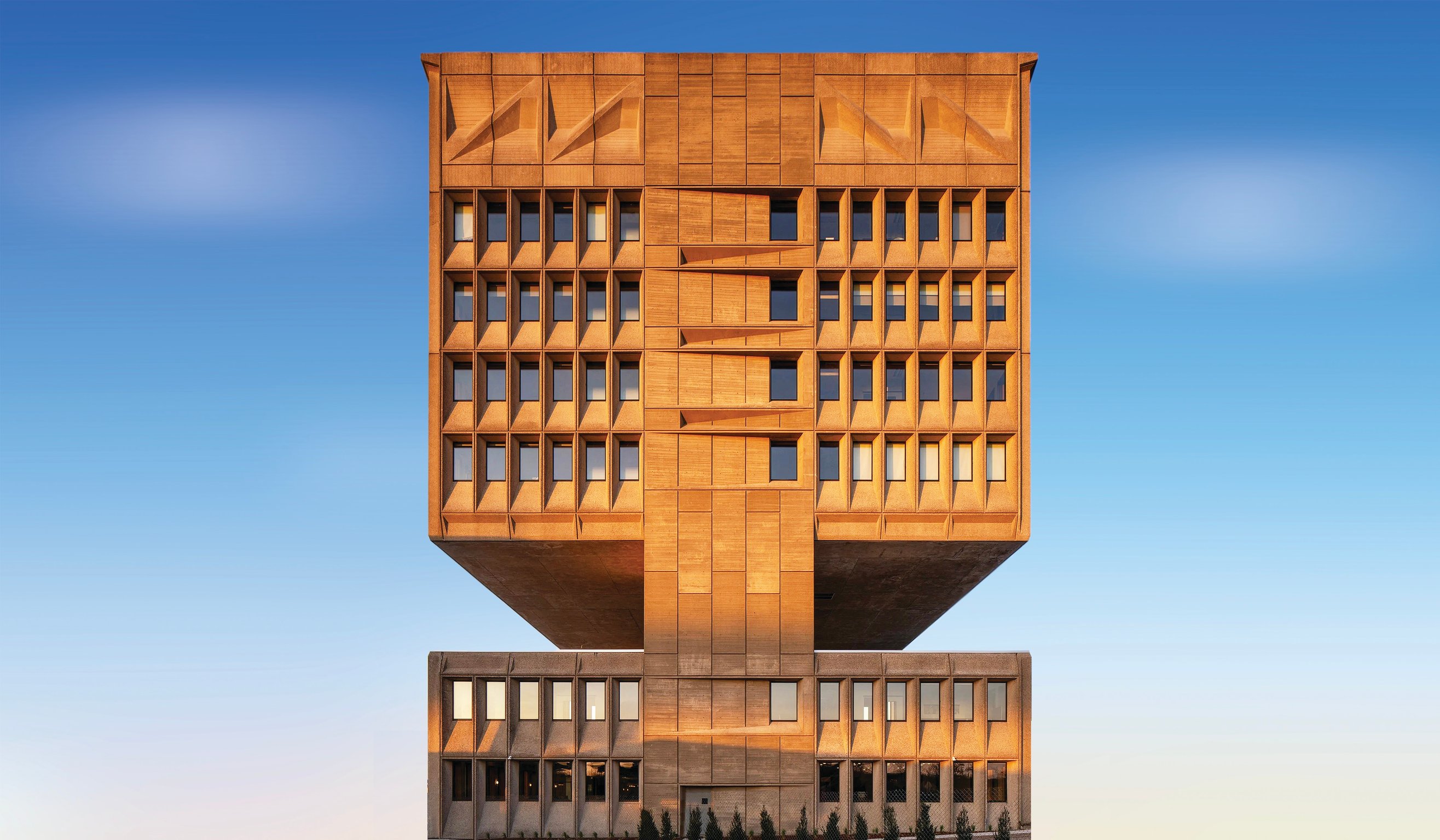 Brutalist concrete tower of Hotel Marcel against a blue sky