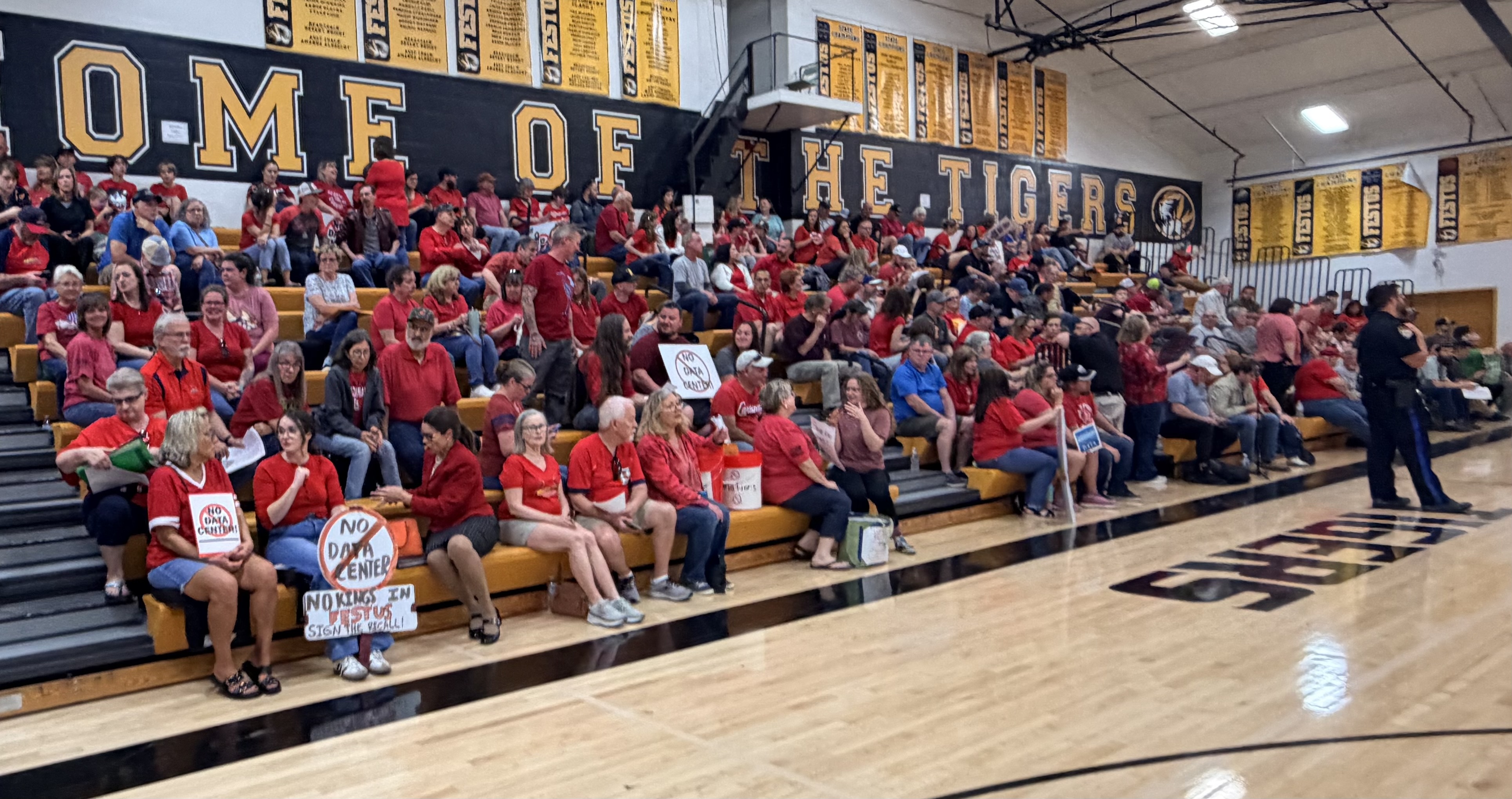 Festus City Council meeting at Festus High School with council and police visible