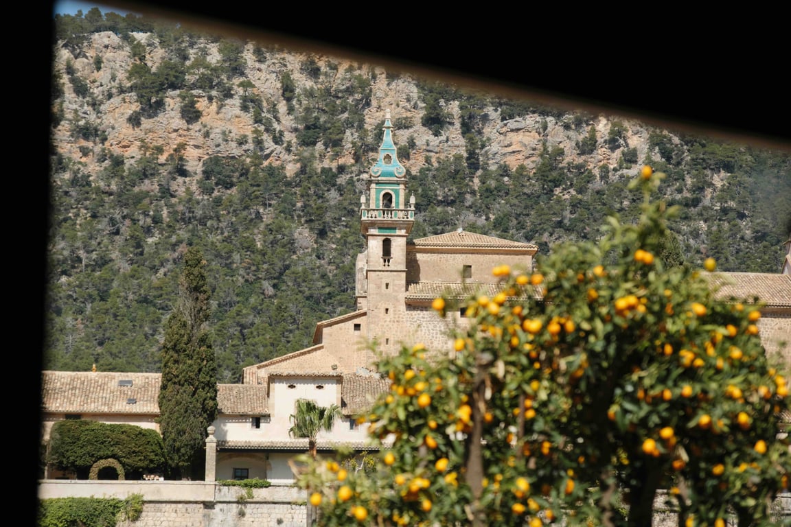 Turquoise monastery spire framed by the mountains of Valldemossa