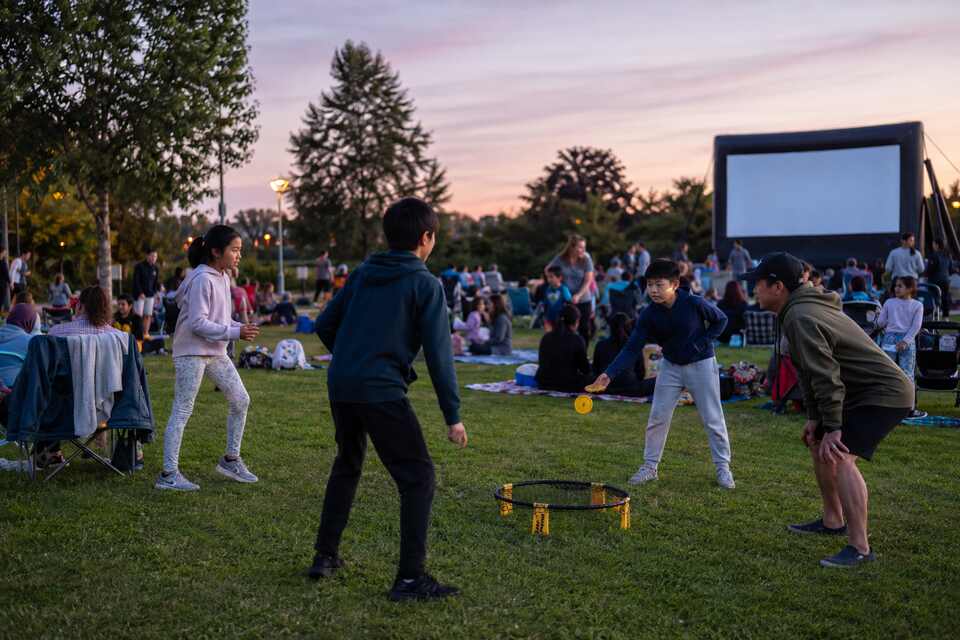 Families enjoying lawn games before an outdoor movie at Hamilton Community Park in Richmond BC
