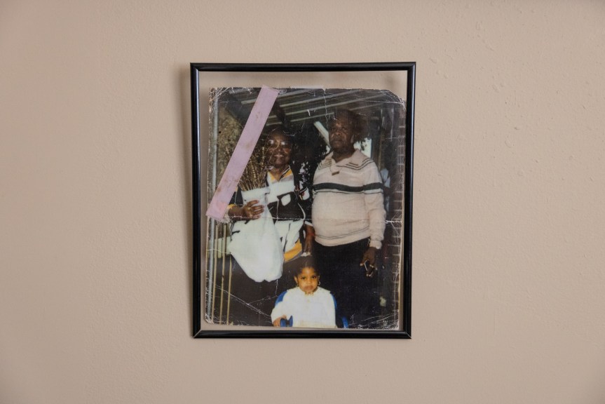A photo of Brooks’ parents and his great-niece hangs in the apartment at a senior center he moved into since his release from prison.