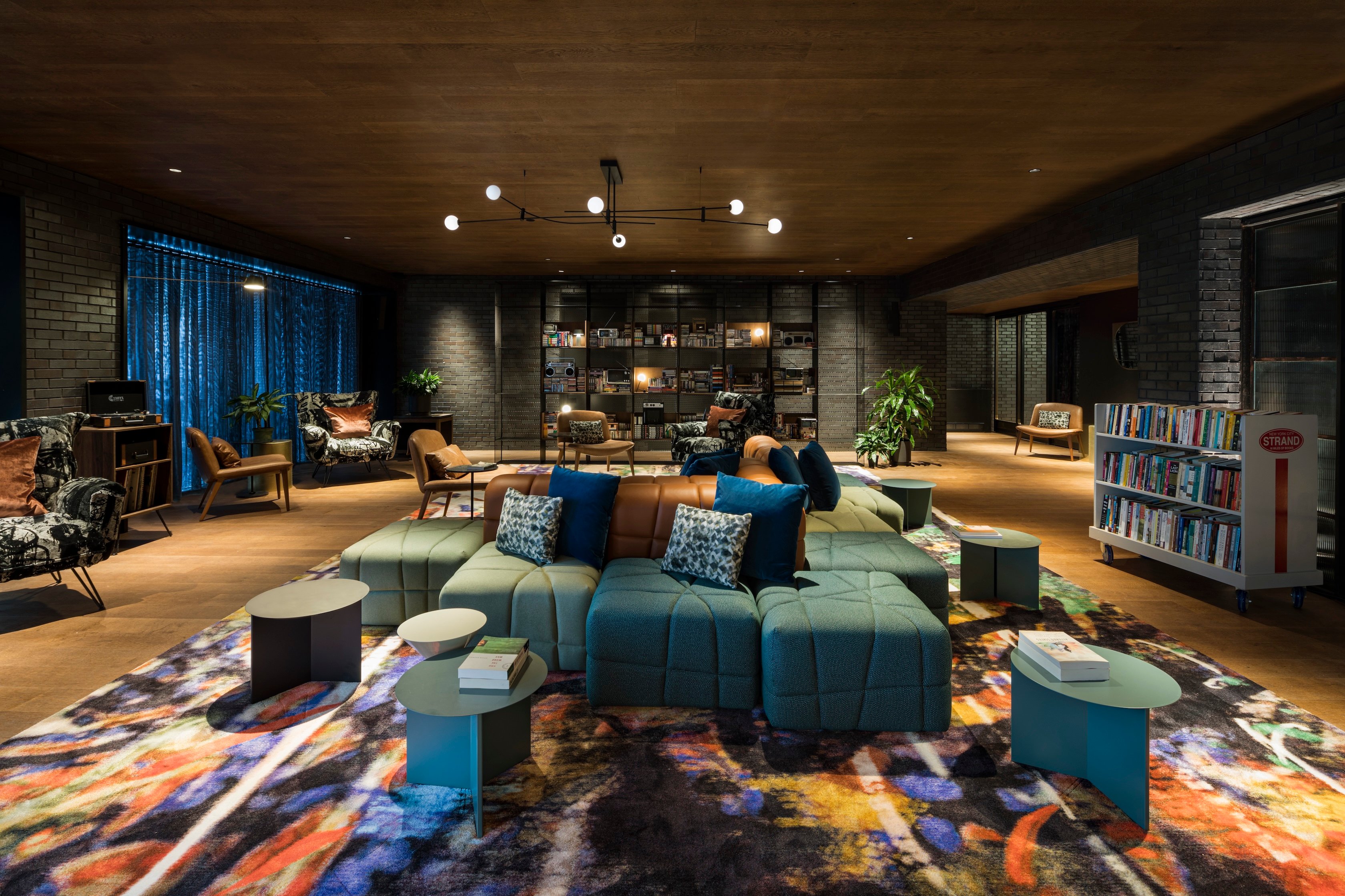 Moxy East Village lobby lounge with colorful seating and a patterned rug