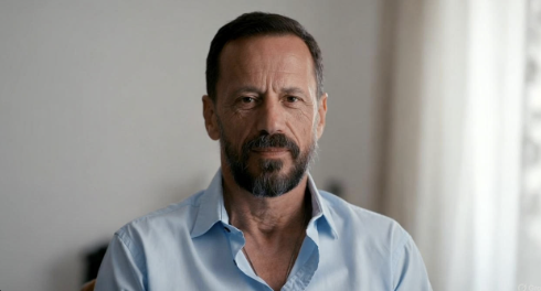 Man seated calmly practicing slow breathing