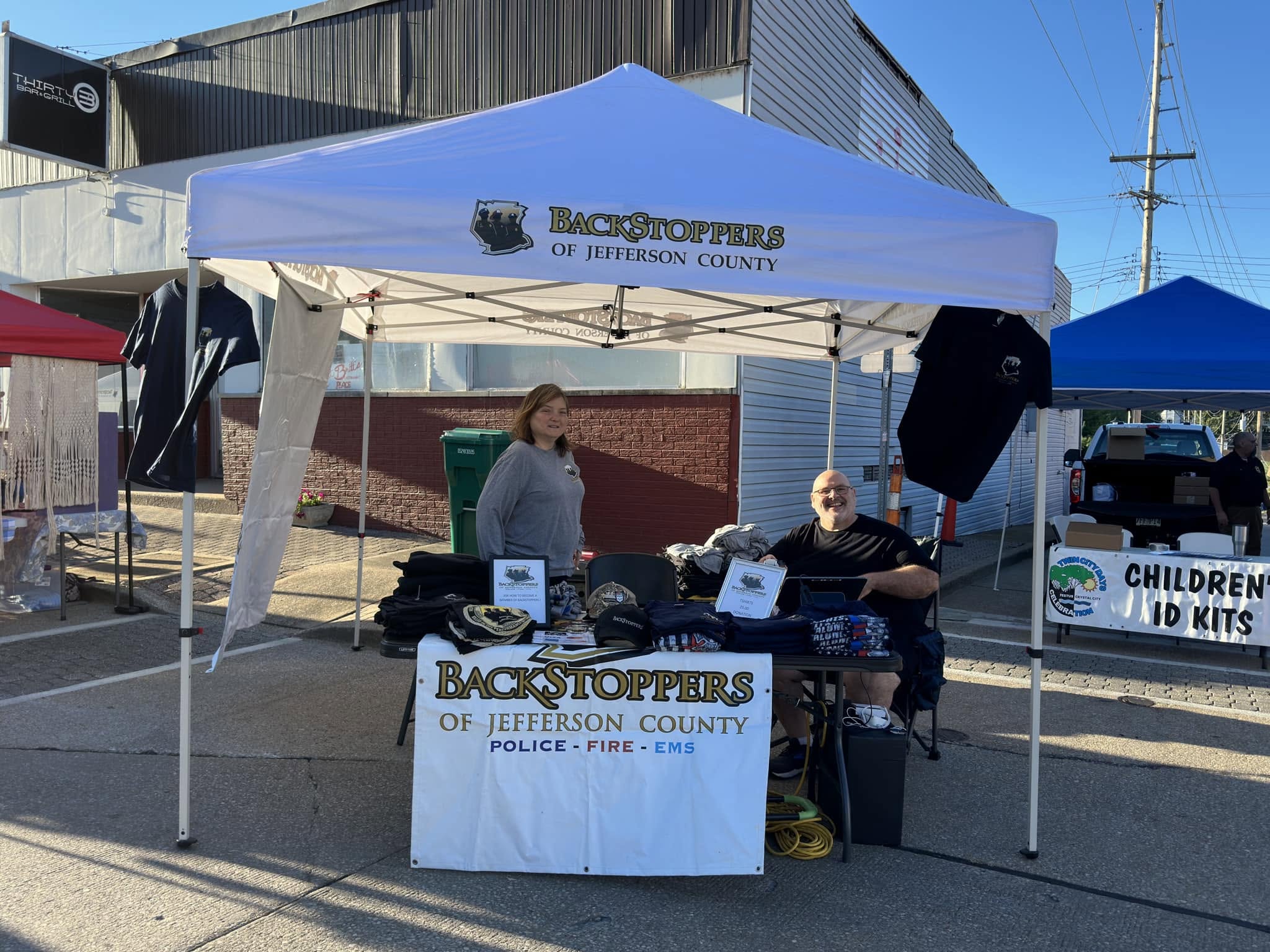 BackStoppers of Jefferson County tent with merchandise and information table