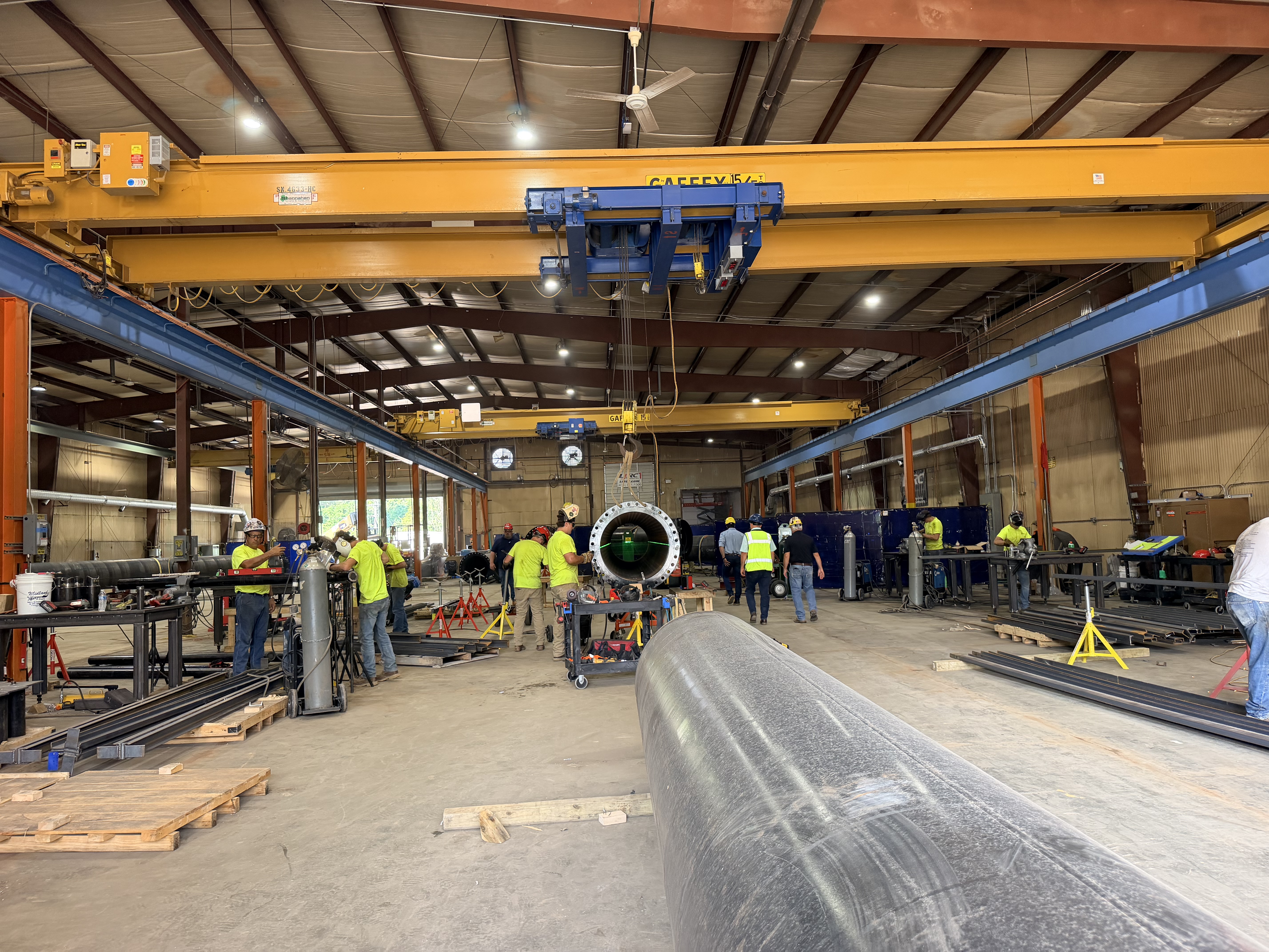 Workers inside a Plumbers and Pipefitters Local 562 fabrication shop