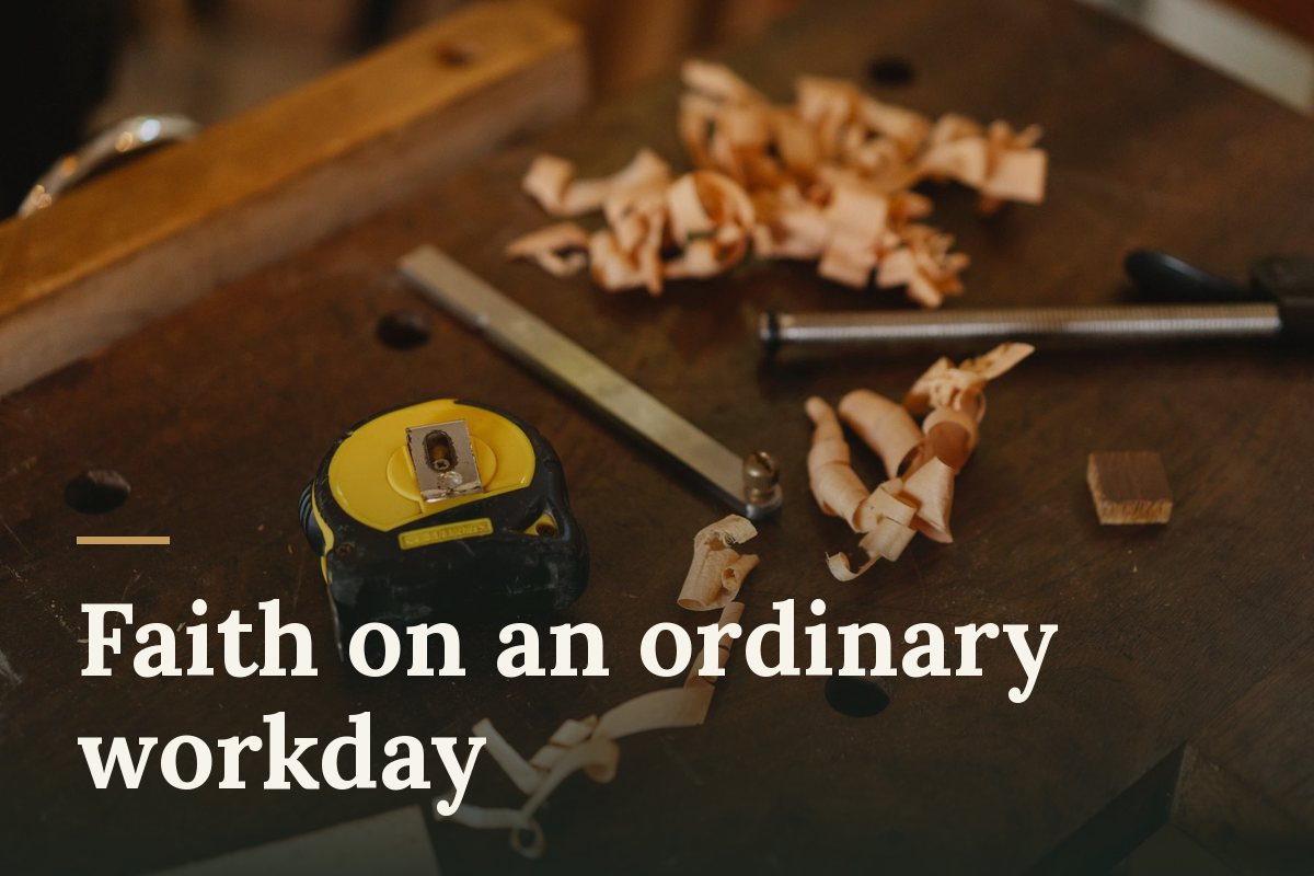 Faith on an ordinary workday. A yellow tape measure and metal tools among curls of wood shavings on a dark wooden workbench