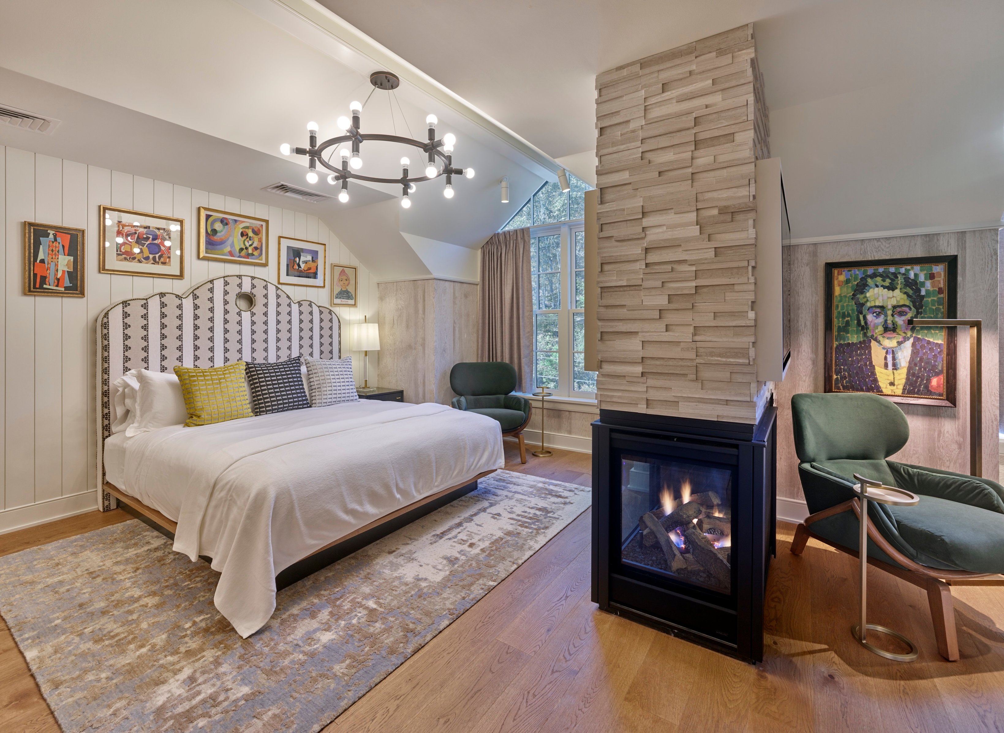 Guest bedroom with fireplace at The River House at Odette’s