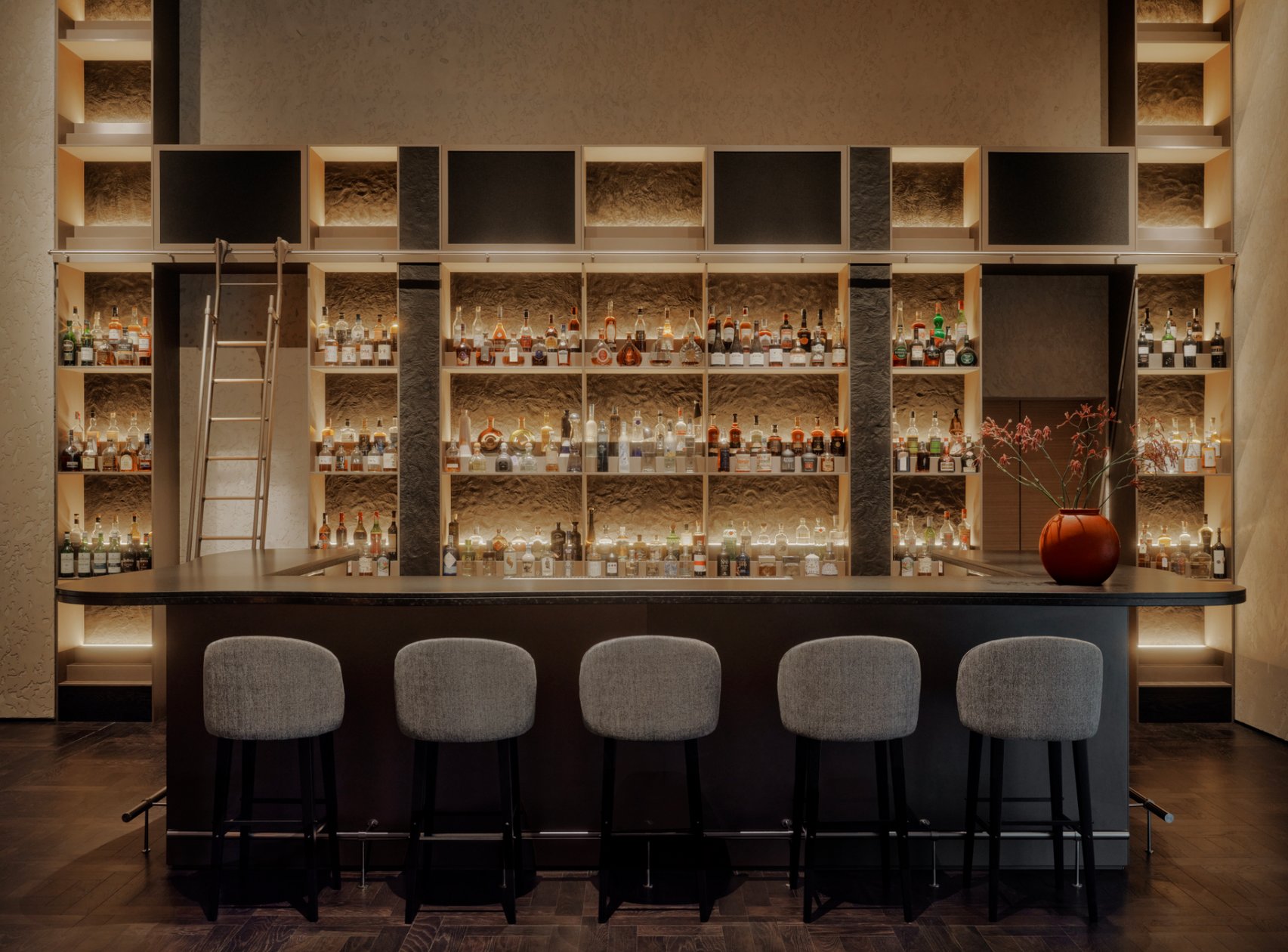 Modern bar with backlit shelves at Aman Rosa Alpina