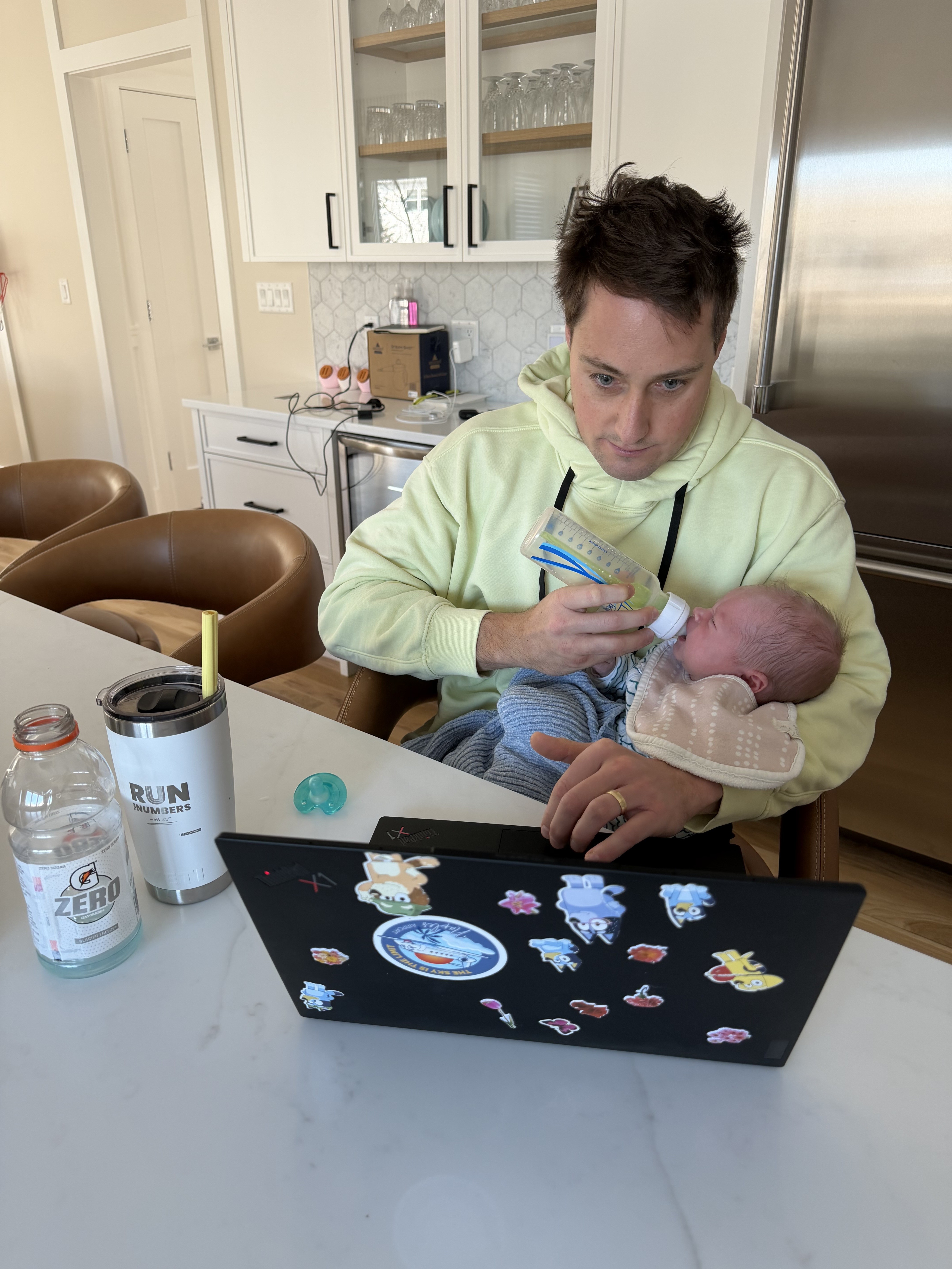 CJ working from home while feeding his baby
