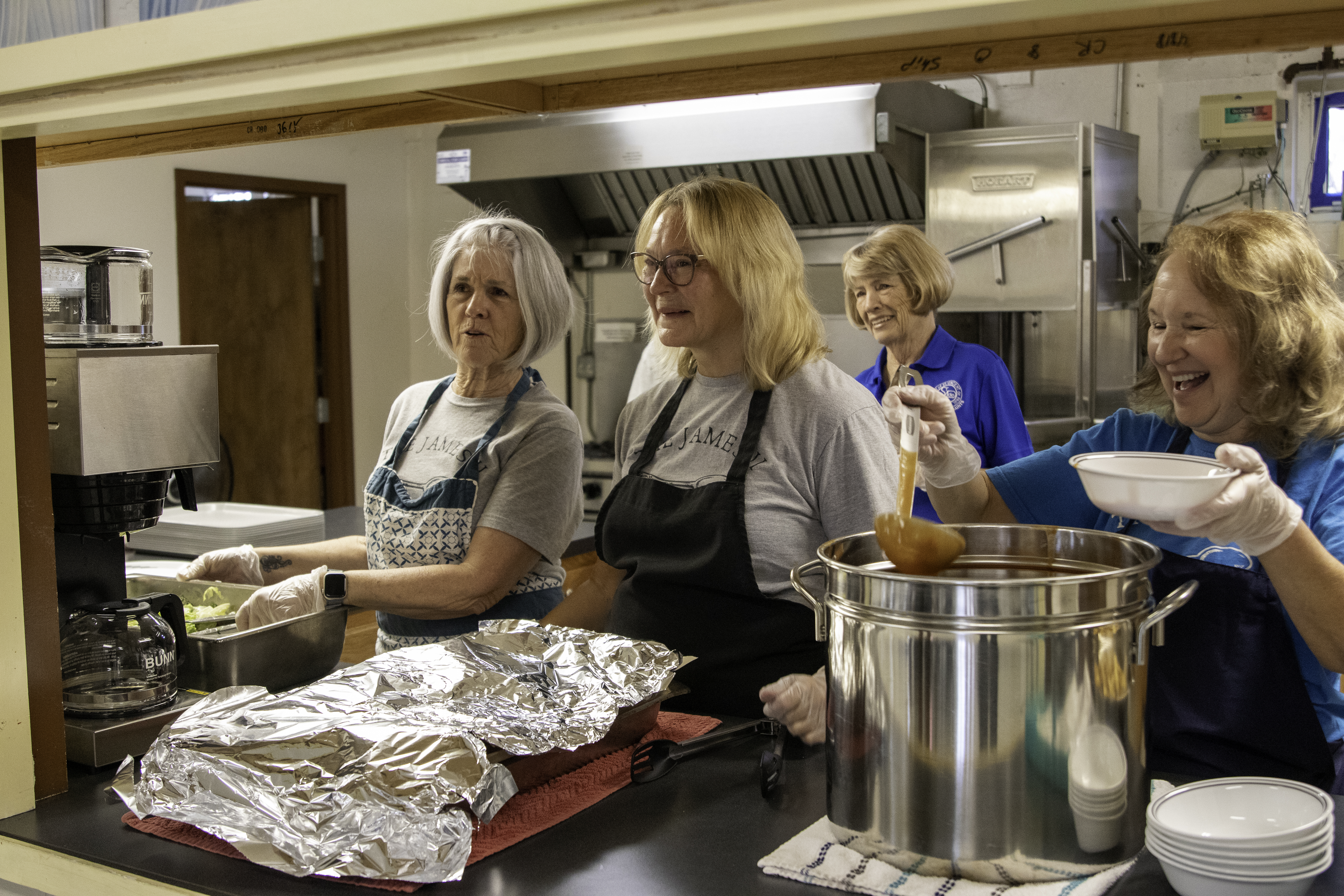Guests and volunteers gathered at a James II Project meal