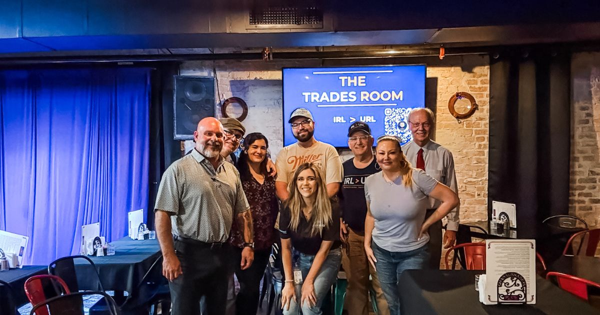 The first Trades Room dinner group photo - trades owners around a real table