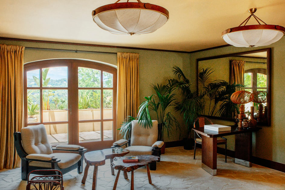Warmly colored lounge overlooking the gardens at Le Mas Candille