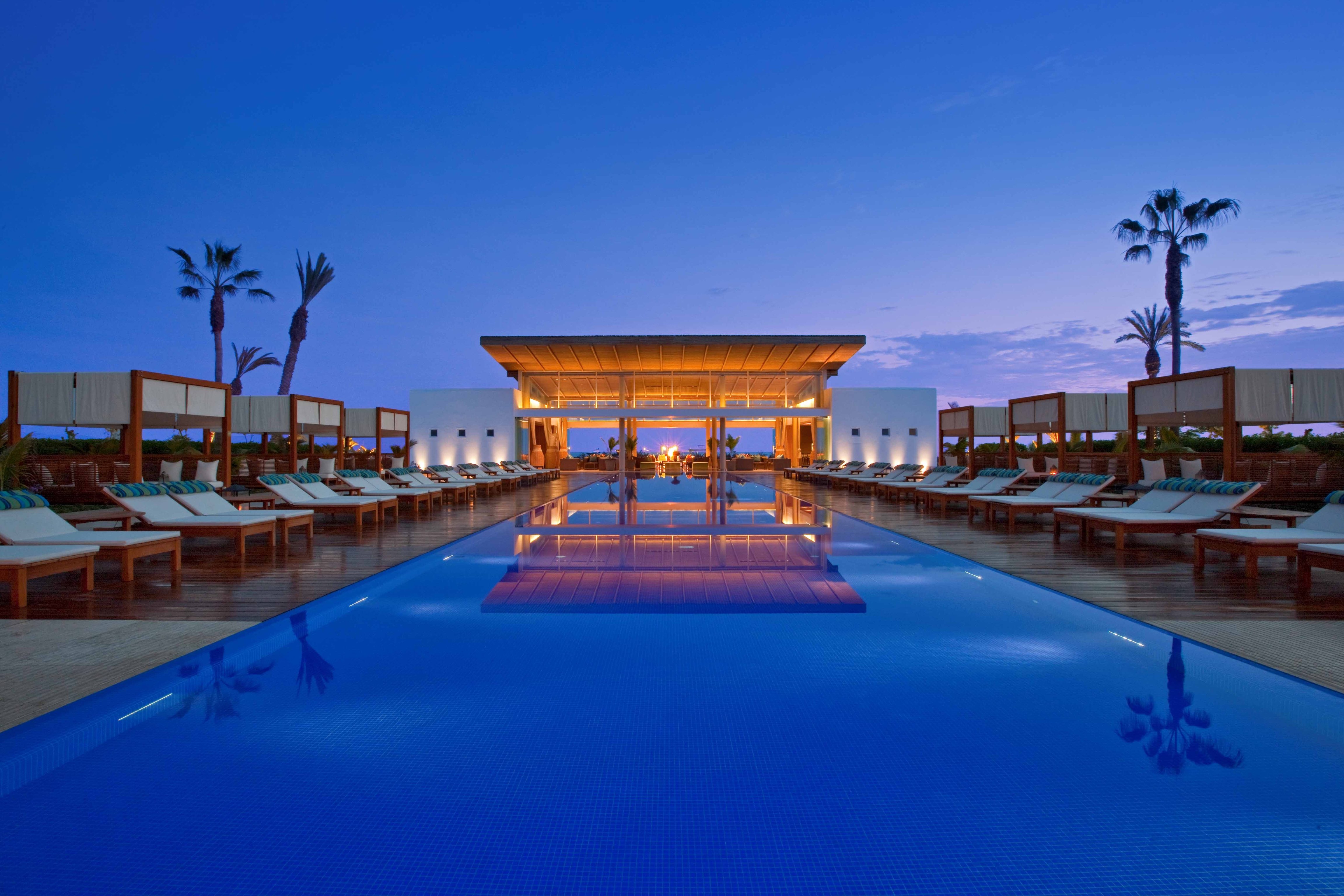 Illuminated pool at Hotel Paracas at dusk