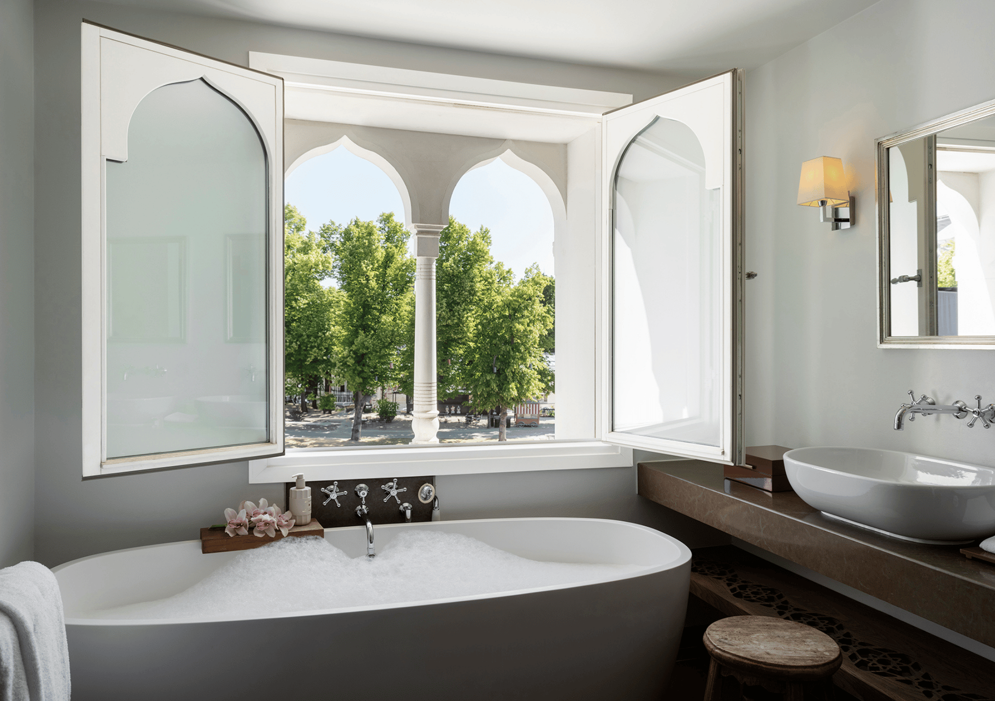 Bright bathroom with a soaking tub overlooking Tivoli Gardens
