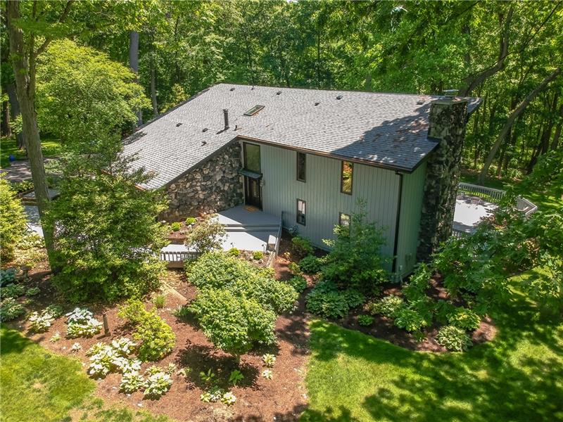 1977 contemporary with cedar siding and a stone chimney
