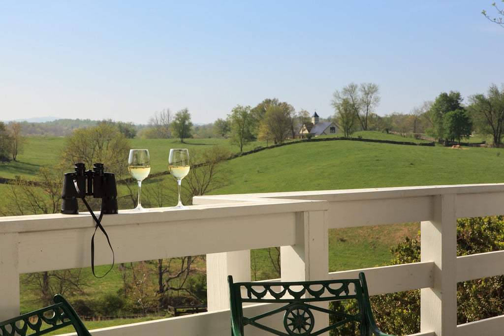 Wine glasses on a terrace overlooking Goodstone Inn’s countryside
