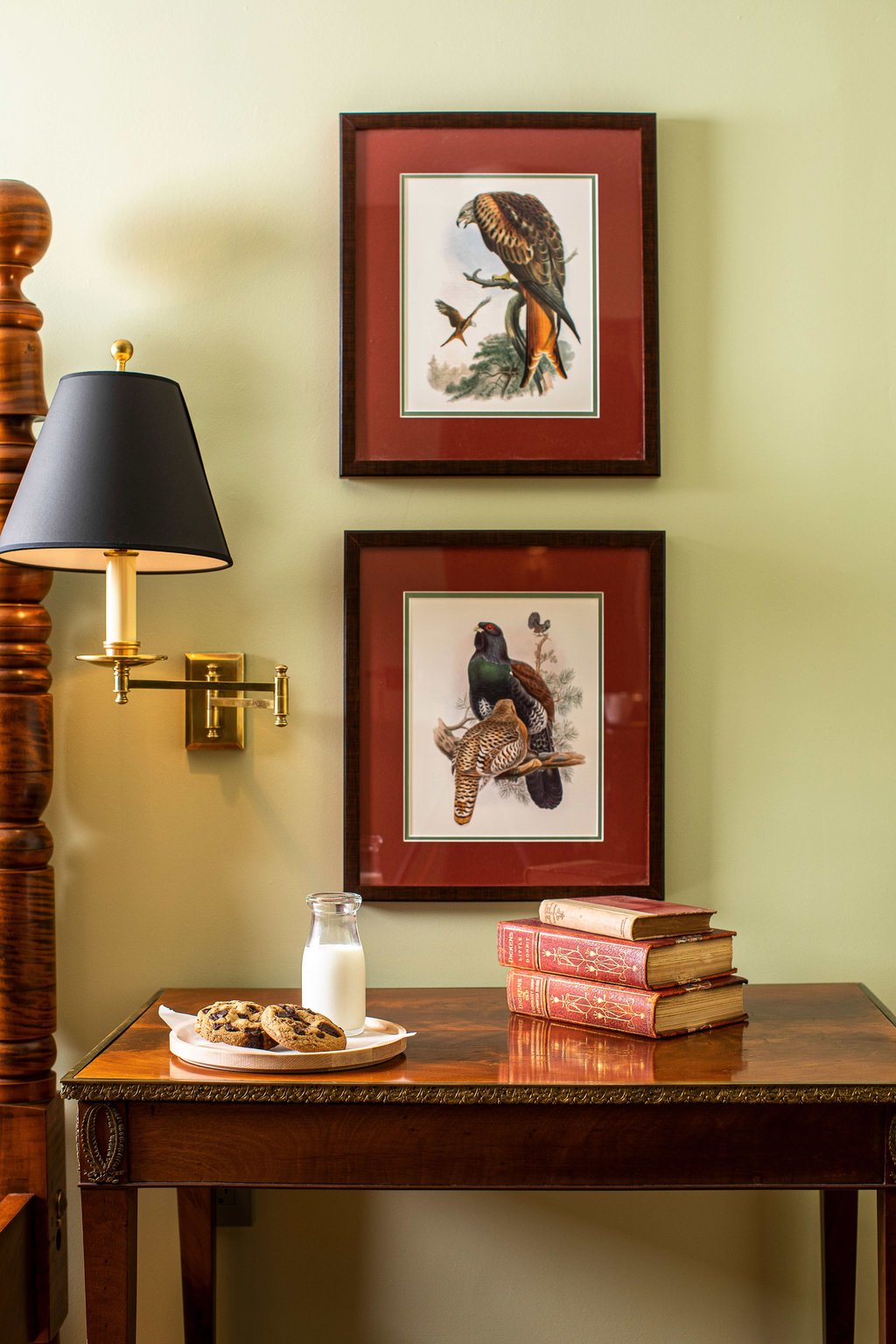 Antique desk and framed artwork in a guest room at The Weston