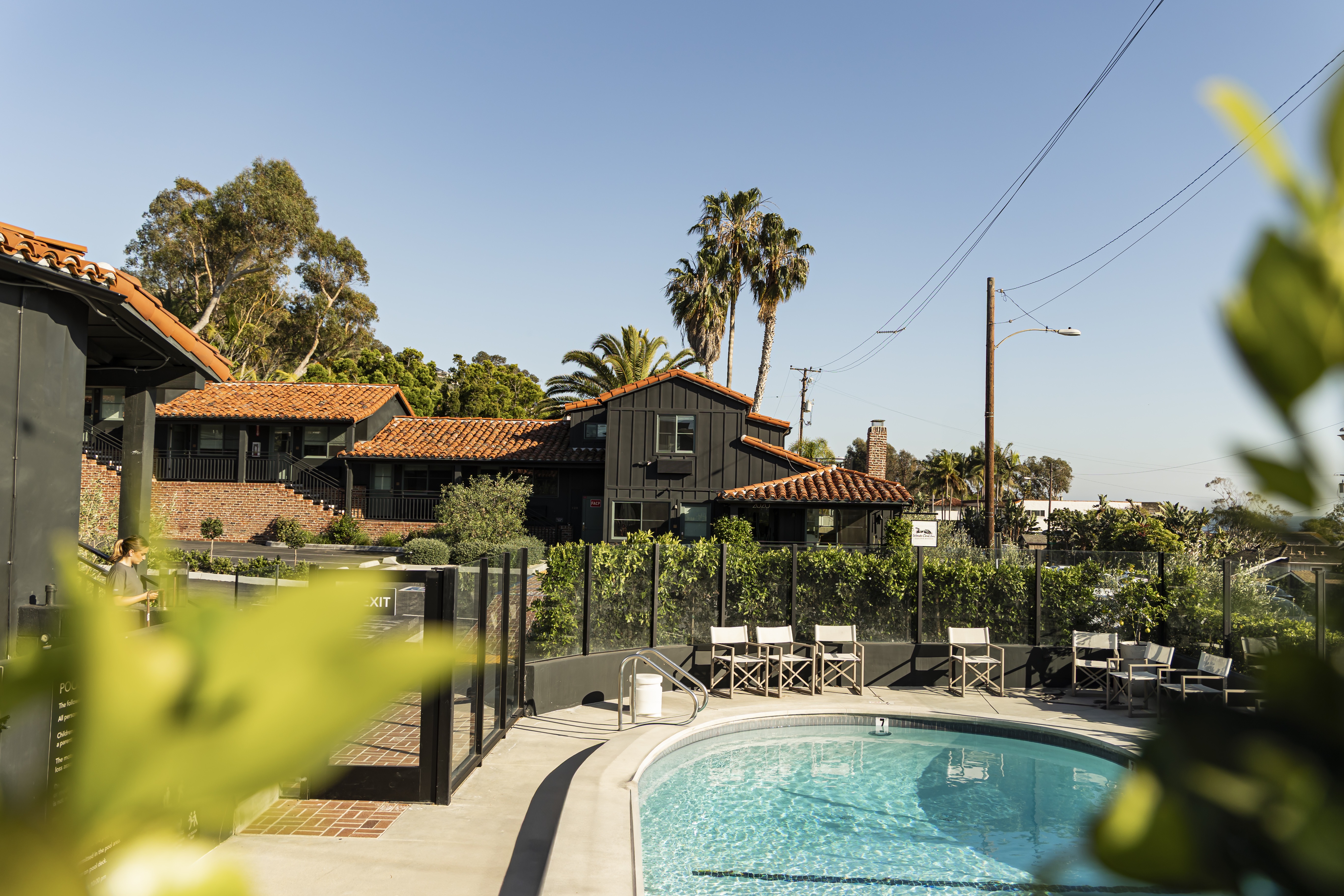 The pool and black-painted exterior at Woods Cove Inn