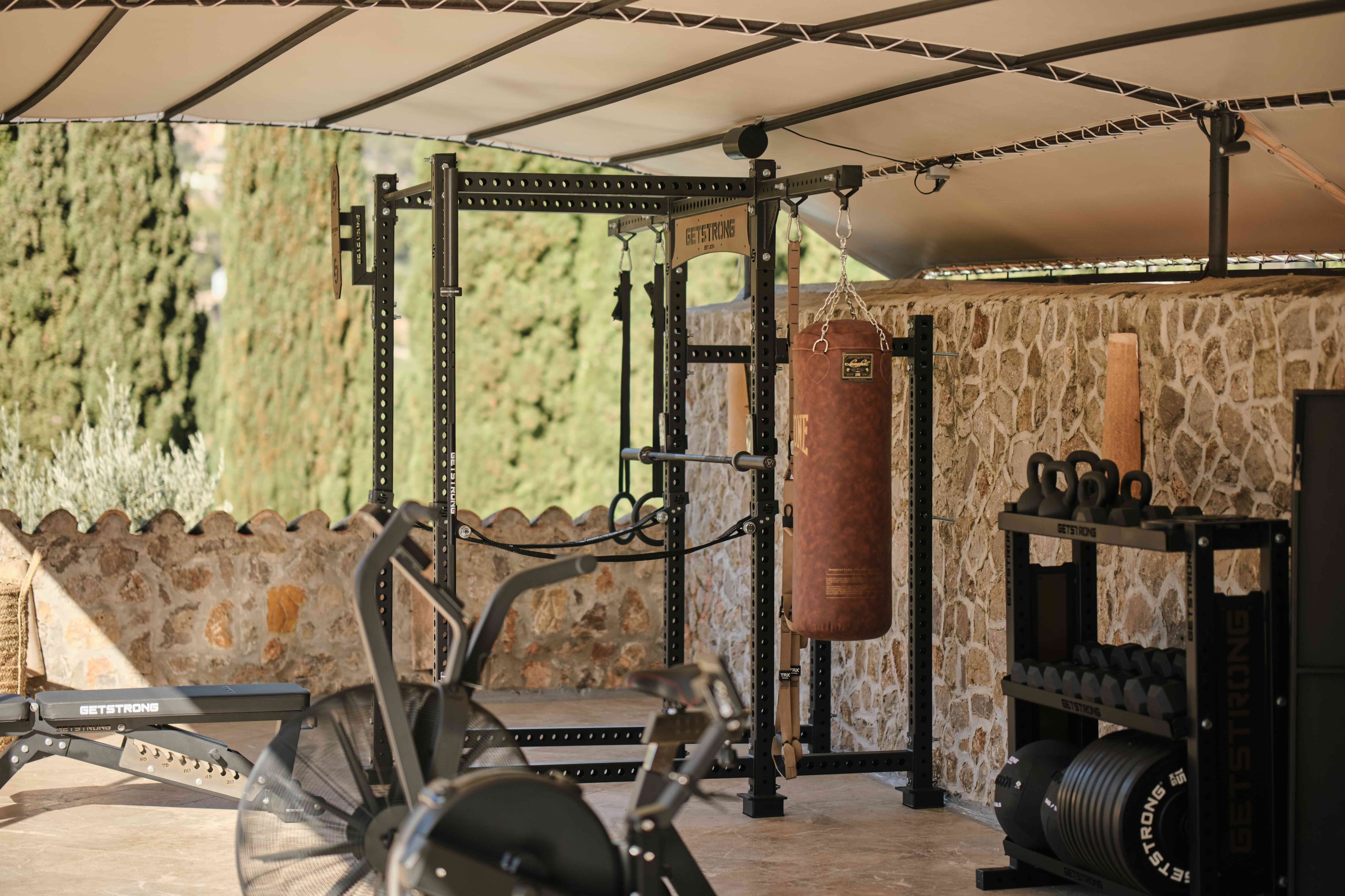 Open-air gym beside a stone wall at Hotel Valldemossa