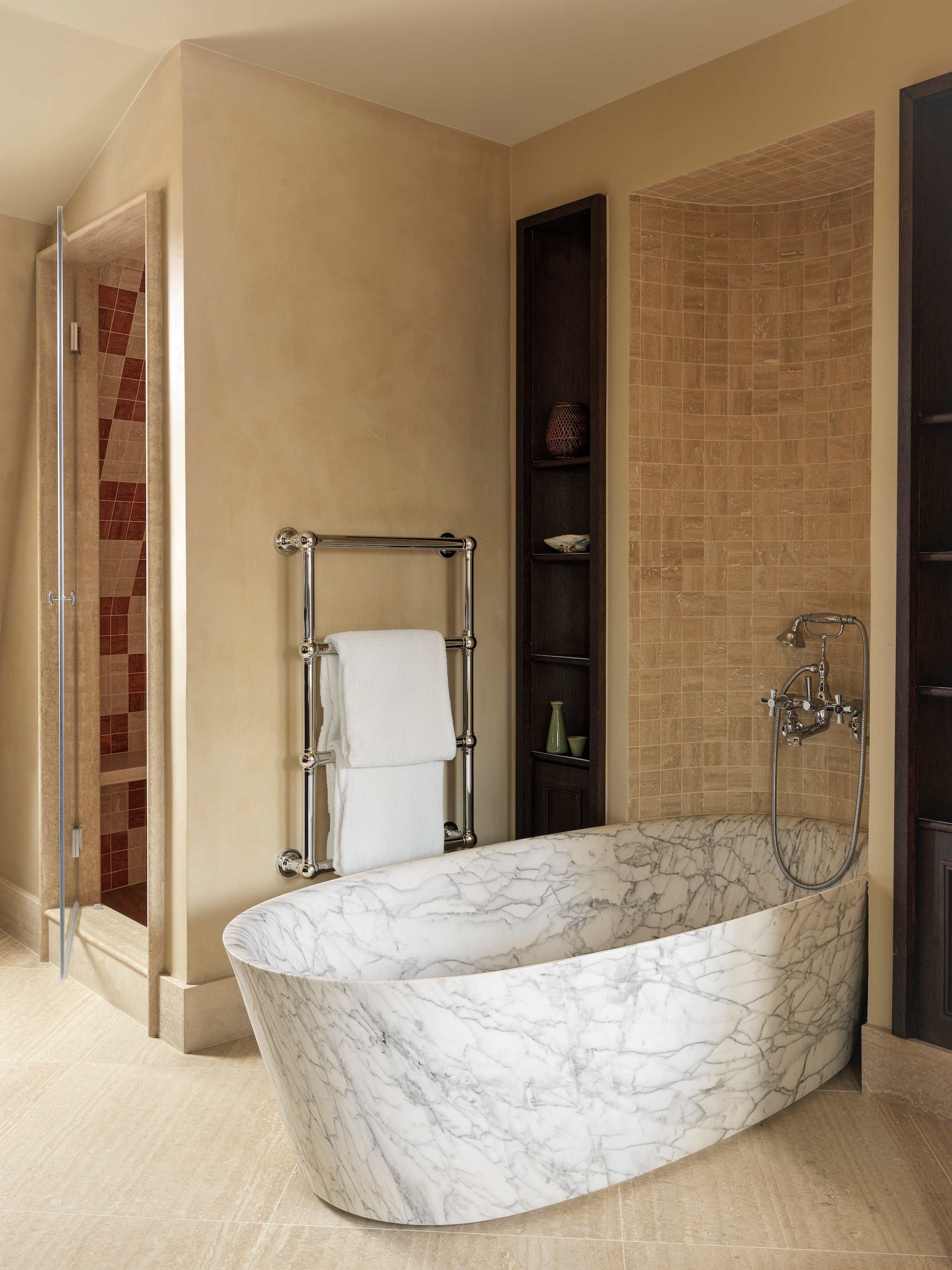 Freestanding marble bathtub in a Hotel Hana bathroom