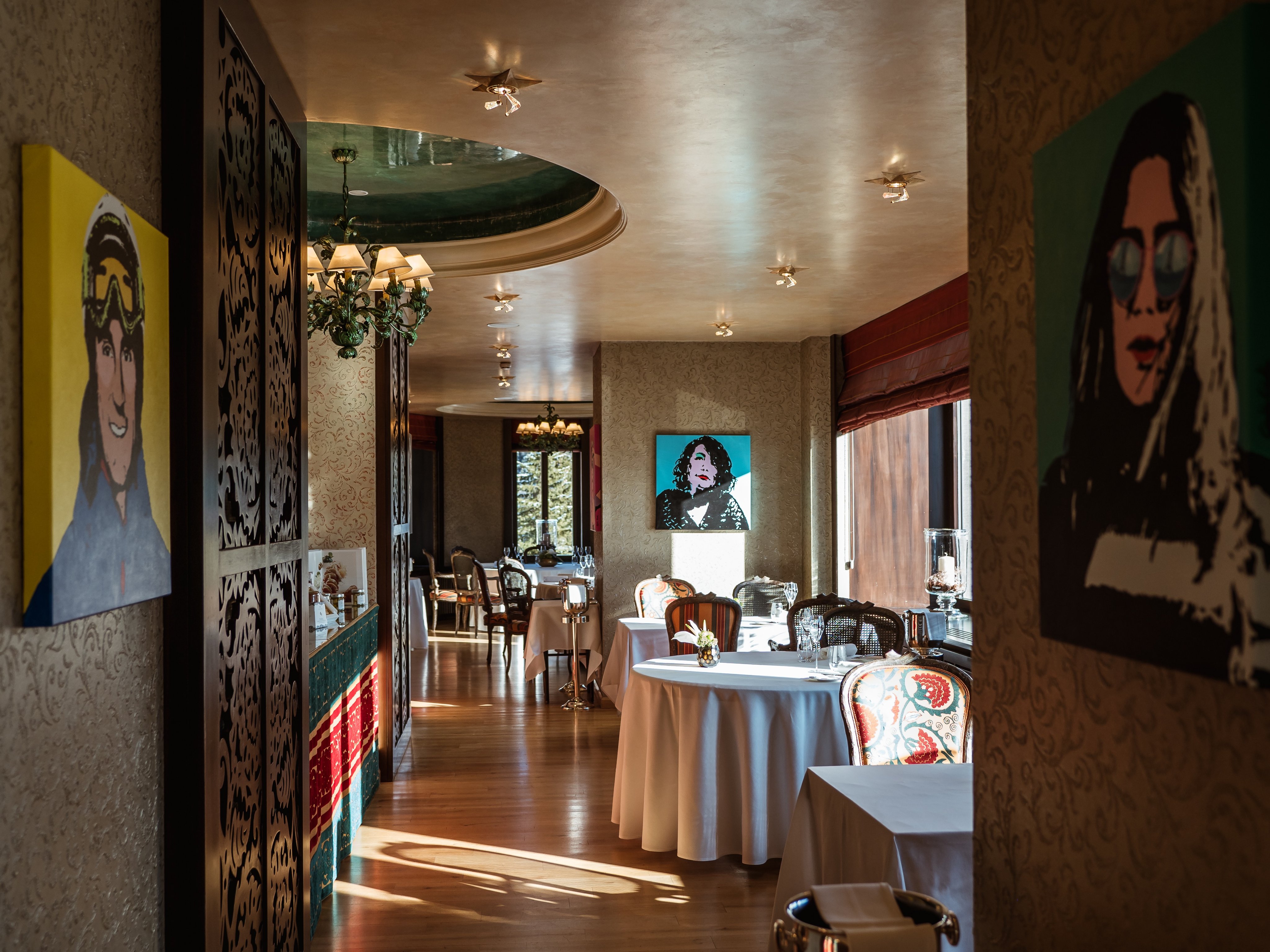 Colorful portraits and tables in Da Vittorio at Carlton Hotel St. Moritz