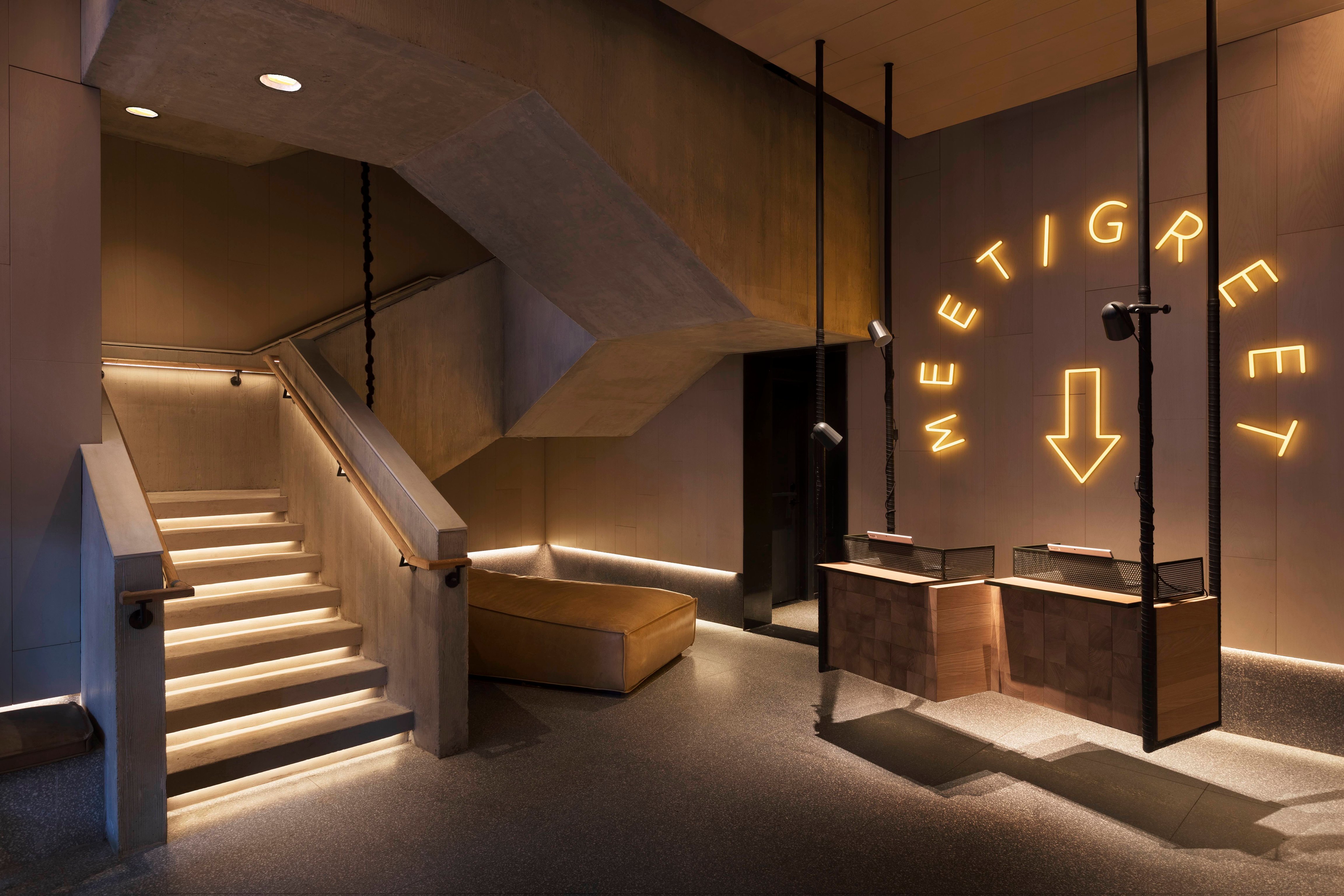 Staircase and neon sign at Moxy Chelsea