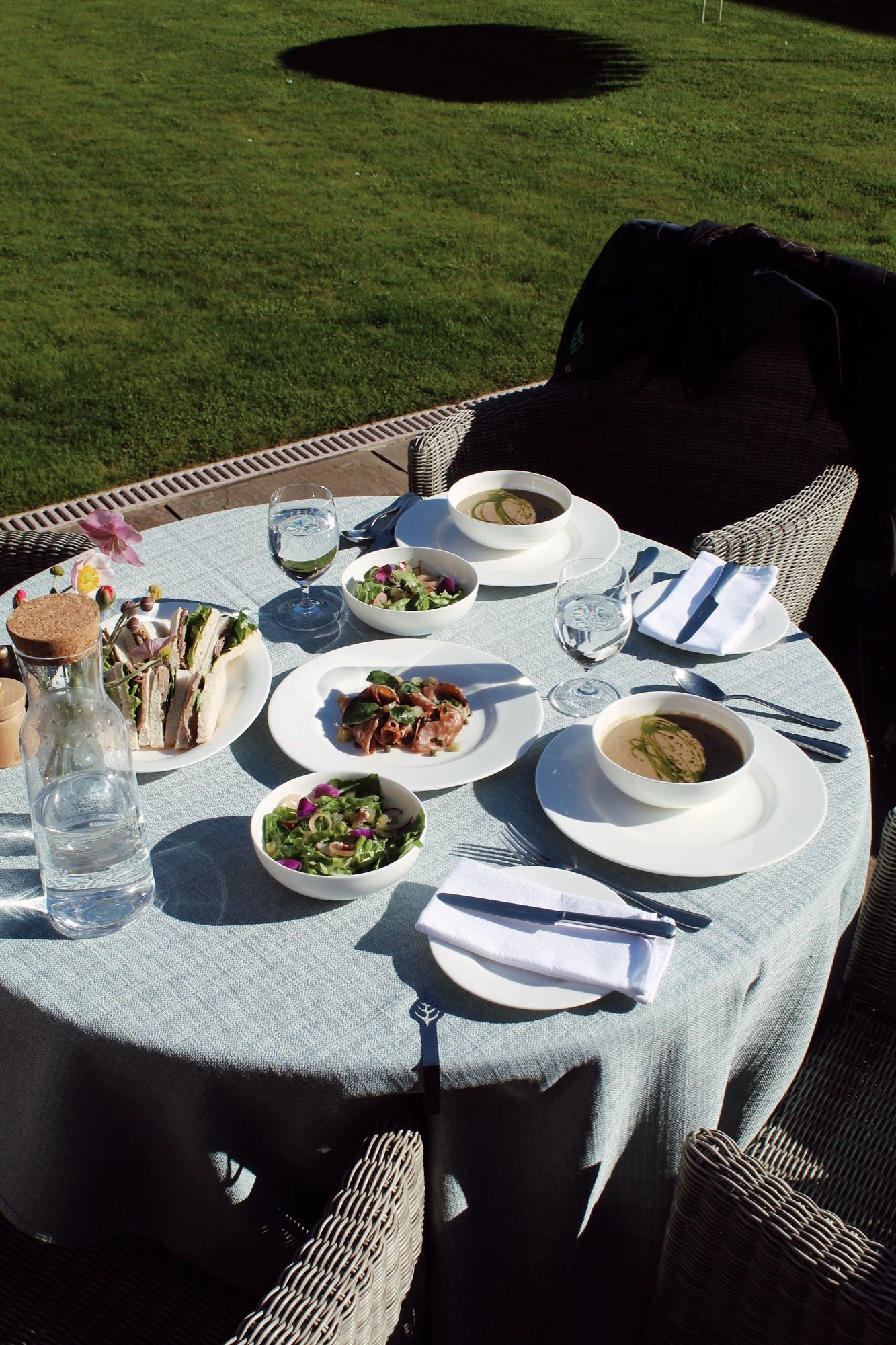 Outdoor dining table on a terrace at Newhall Mains