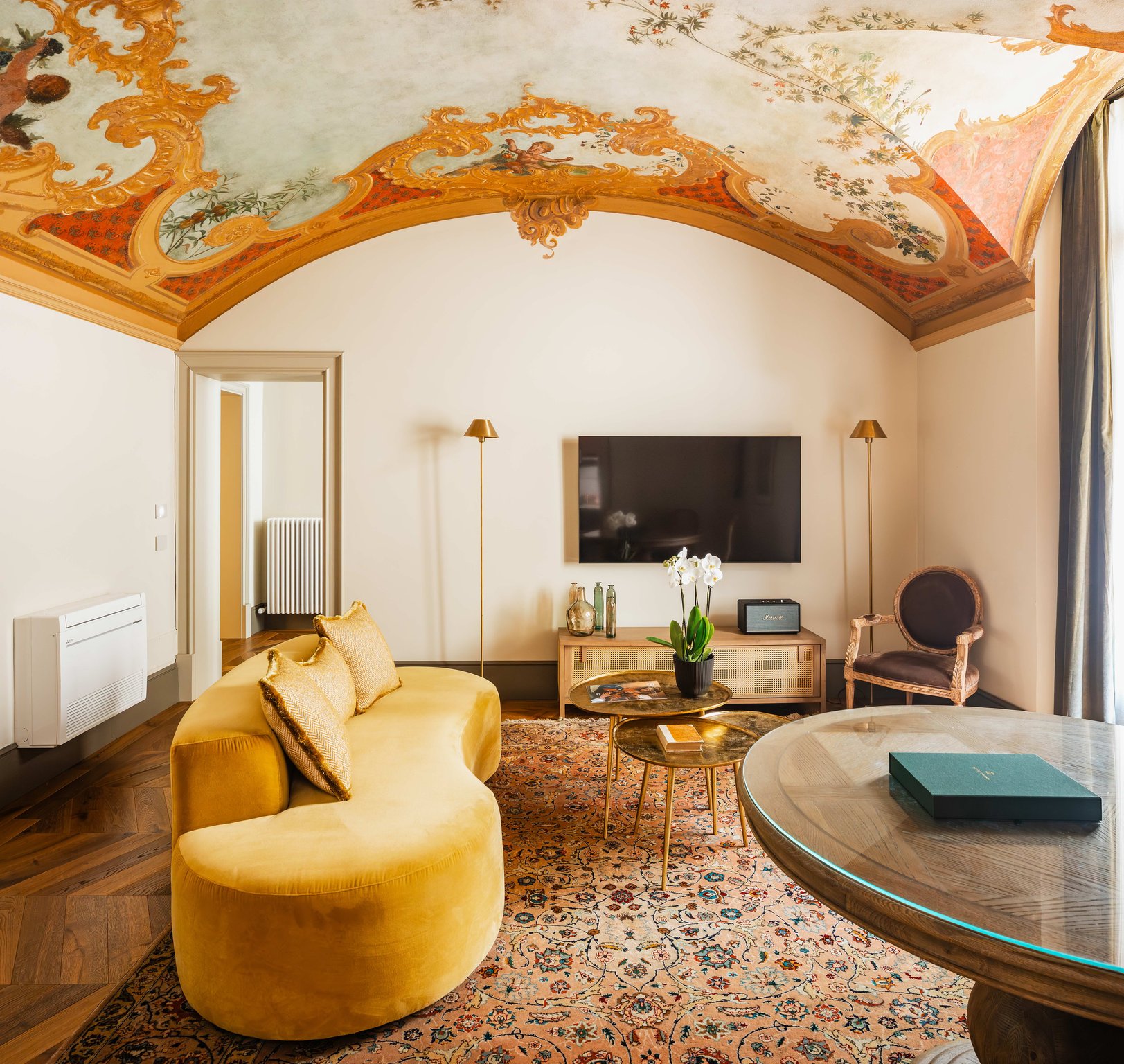 Frescoed ceiling and colorful seating at This Time Tomorrow