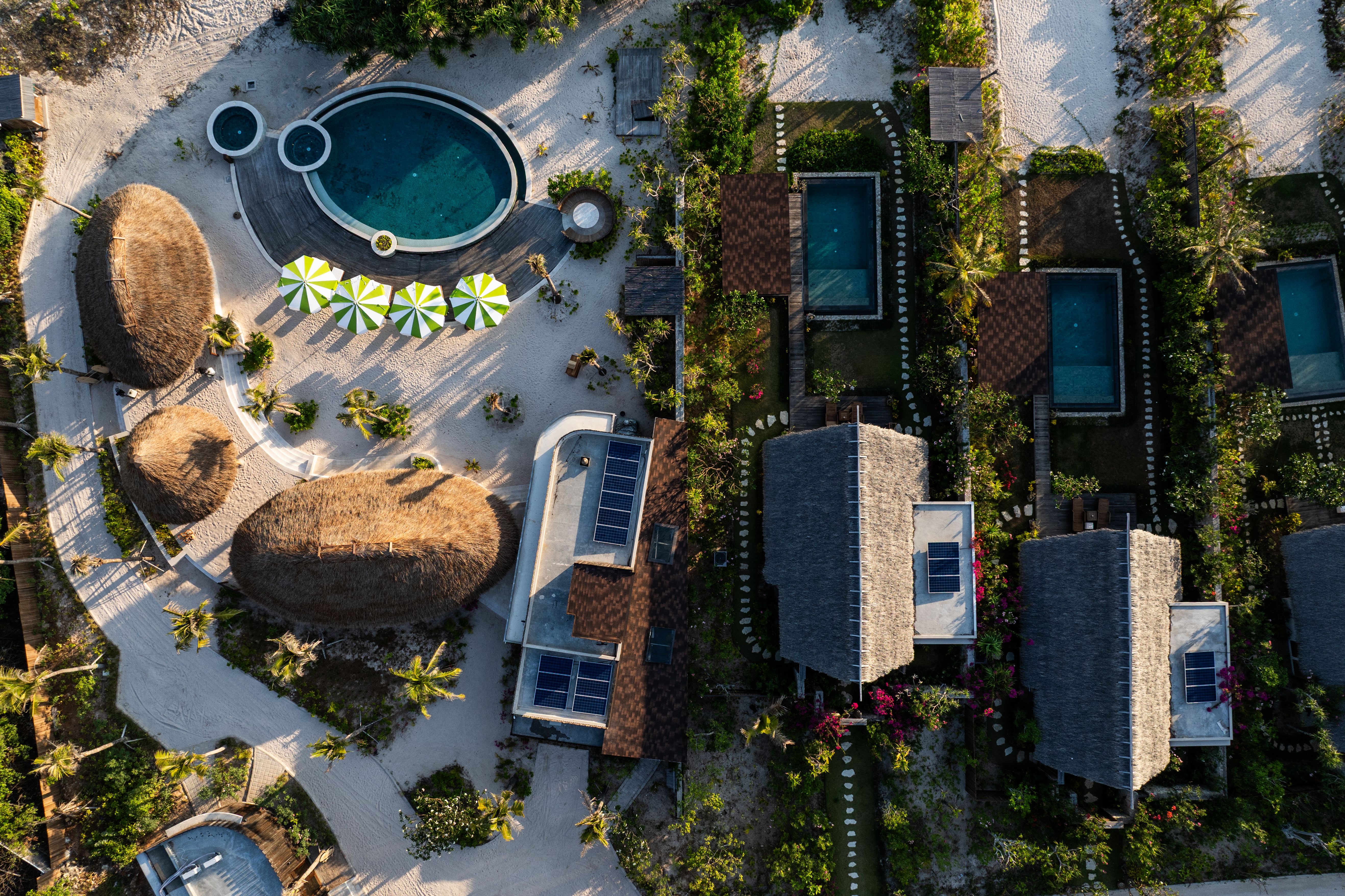 An aerial view of NIHI Rote's villas, pools, and tropical grounds