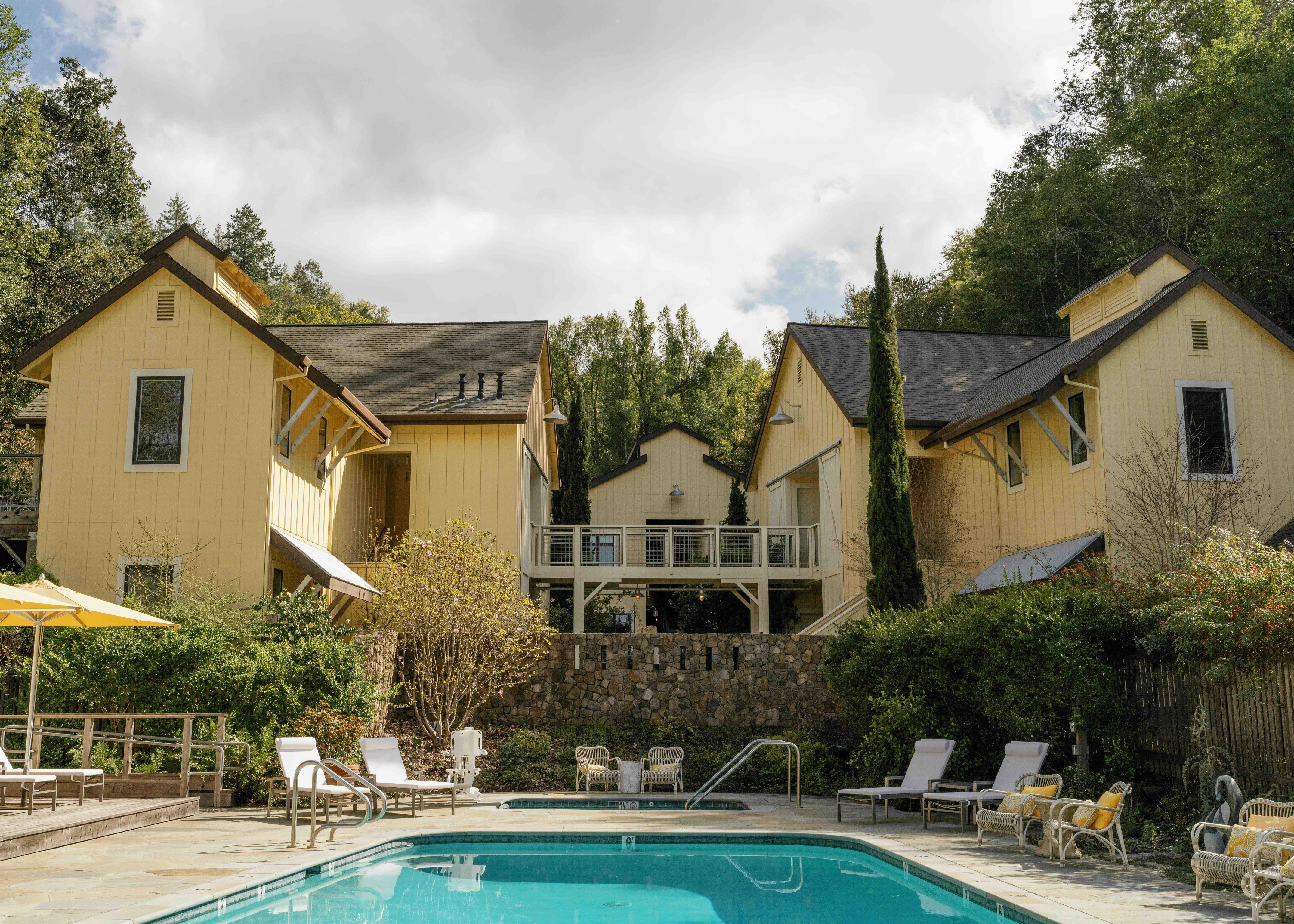 Pool and butter-yellow cottages at Farmhouse Inn
