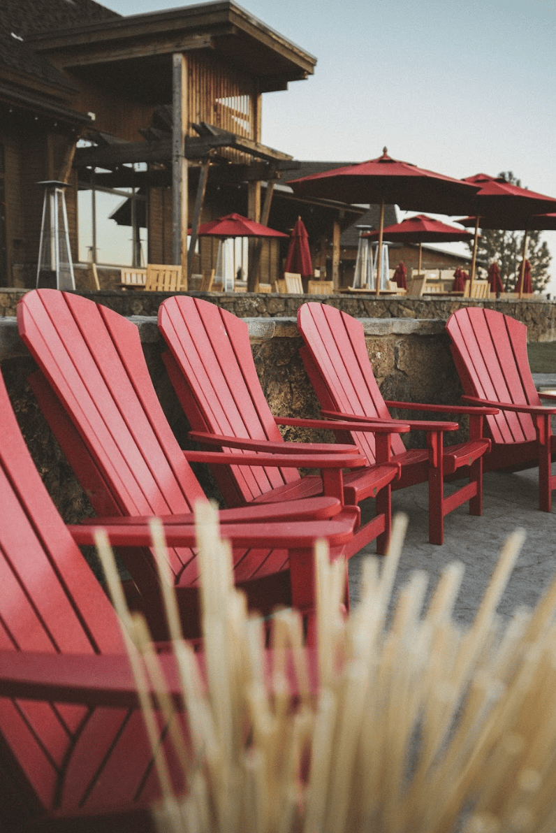 Red Adirondack chairs outside the Ranch House