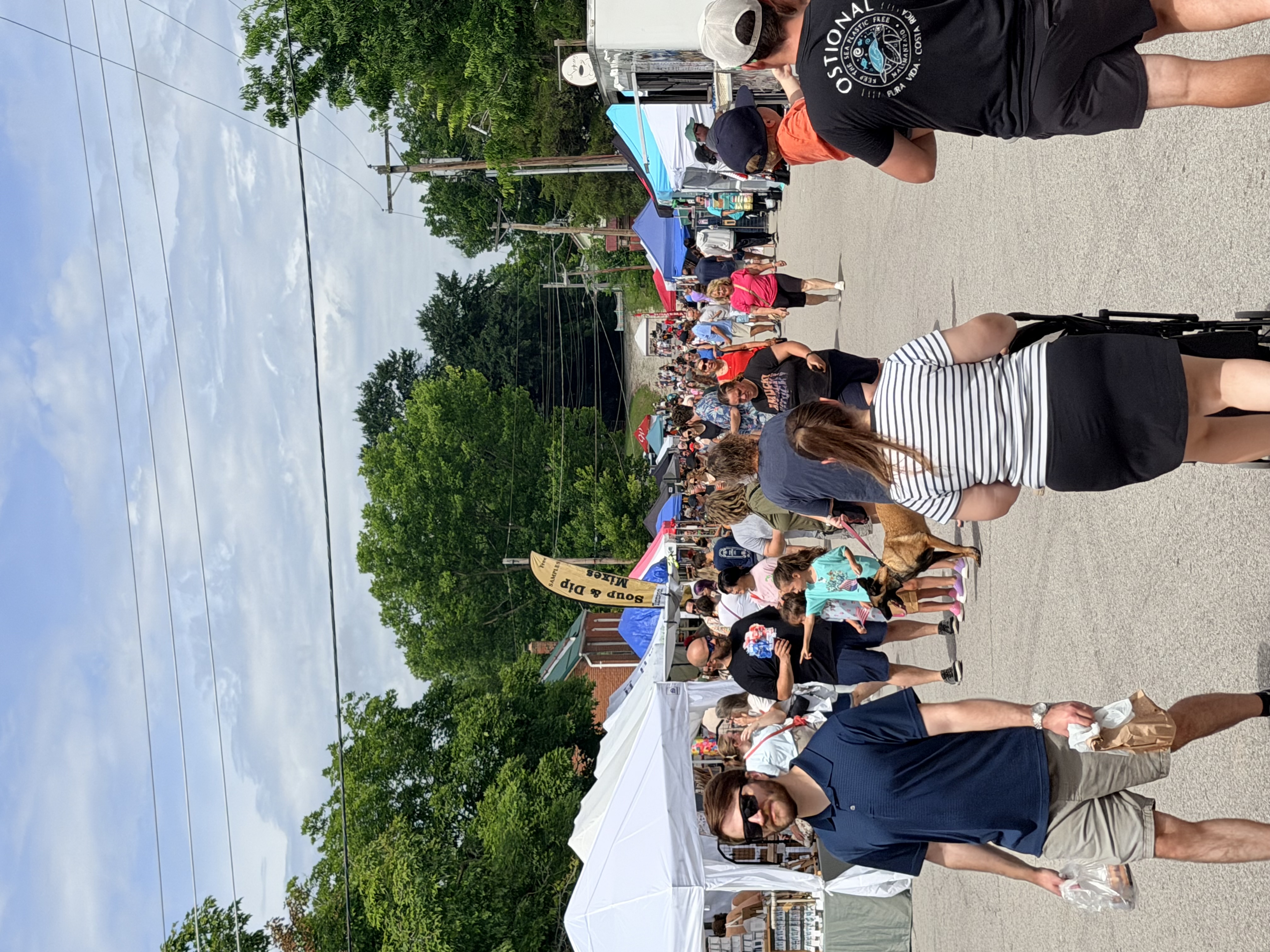 Festival crowds walking between vendor booths in Kimmswick
