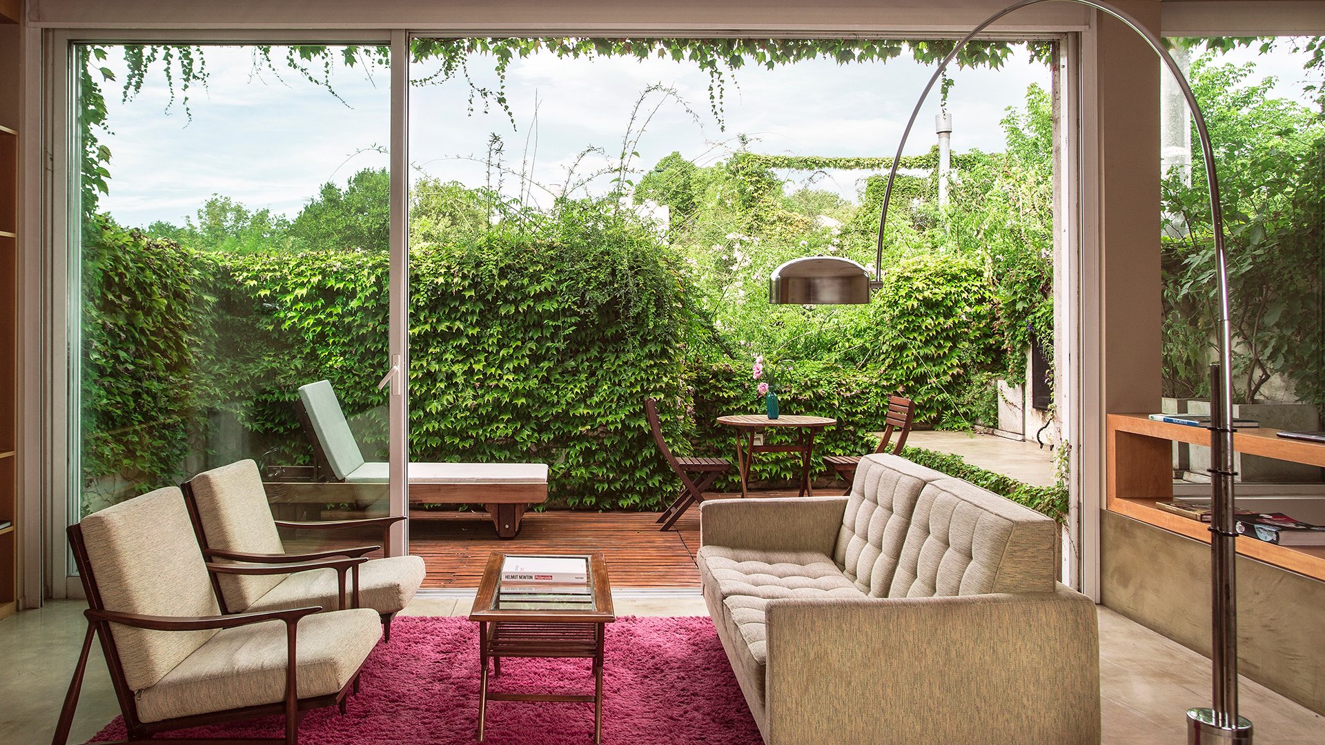 Vintage lounge opening onto a leafy terrace at Home Hotel in Buenos Aires