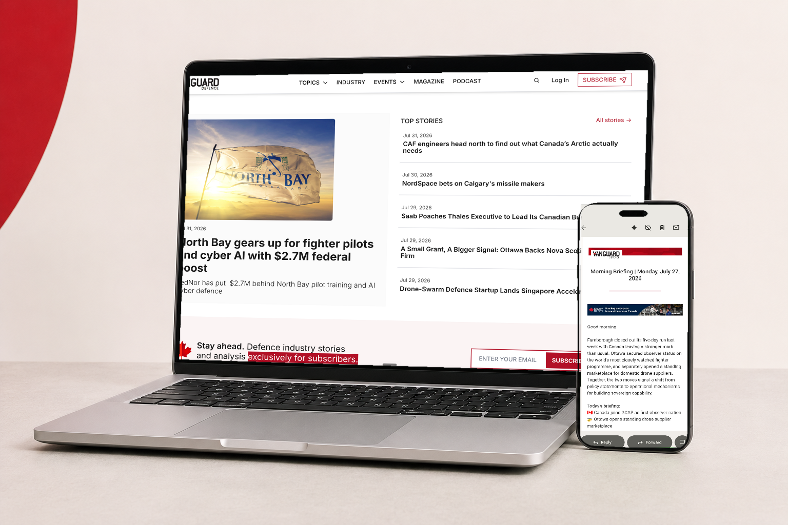 Vanguard Defence website displayed on a laptop and newsletter displayed on a phone