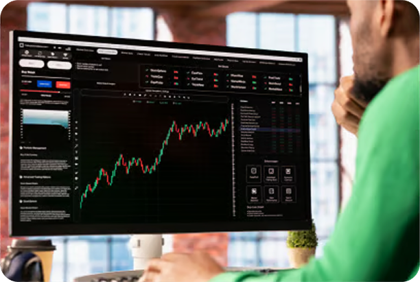Person analyzing trading charts on large monitor