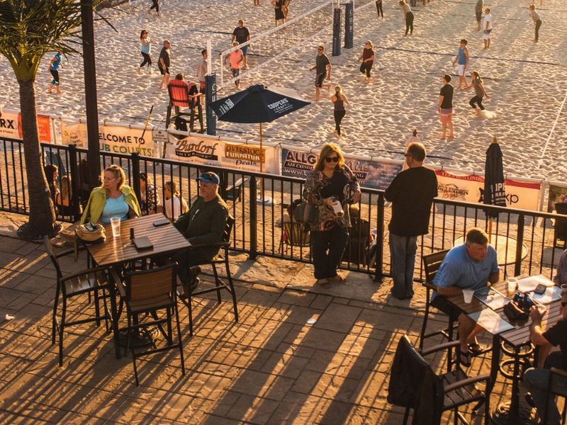 Deck overlooking sand volleyball courts at Blind Squirrel