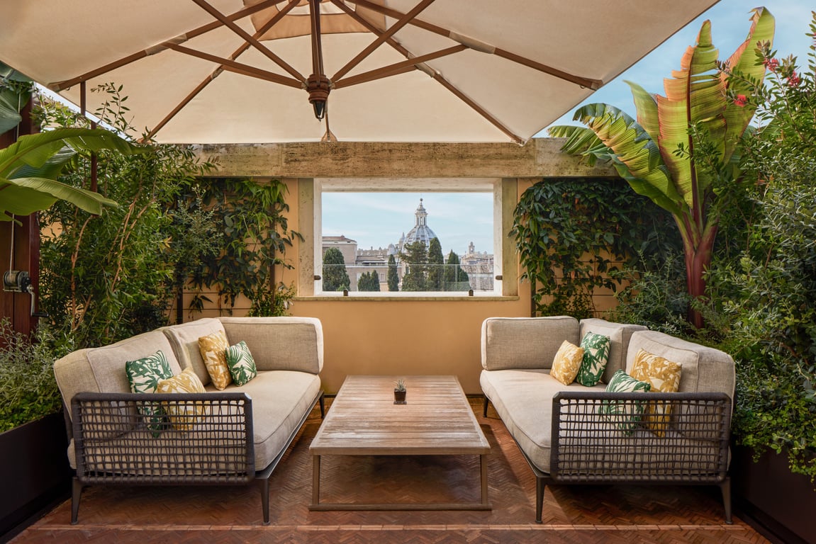 Terrace seating and a view across Rome at Bvlgari Hotel Roma