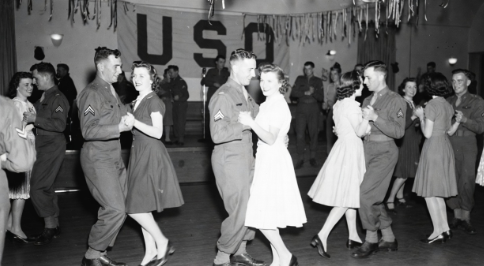 Vintage photo of a USO dance hall with soldiers and volunteers