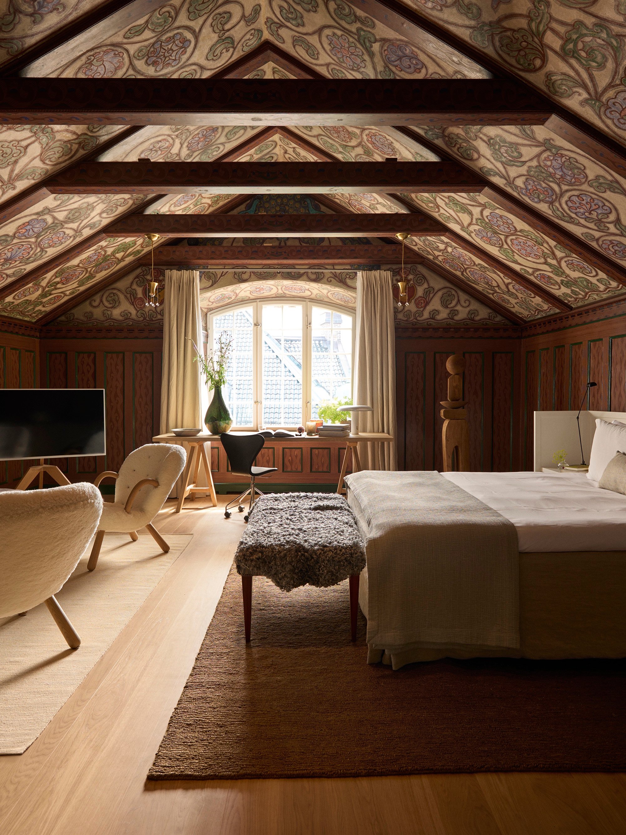 Attic suite with painted ceiling beams at Ett Hem