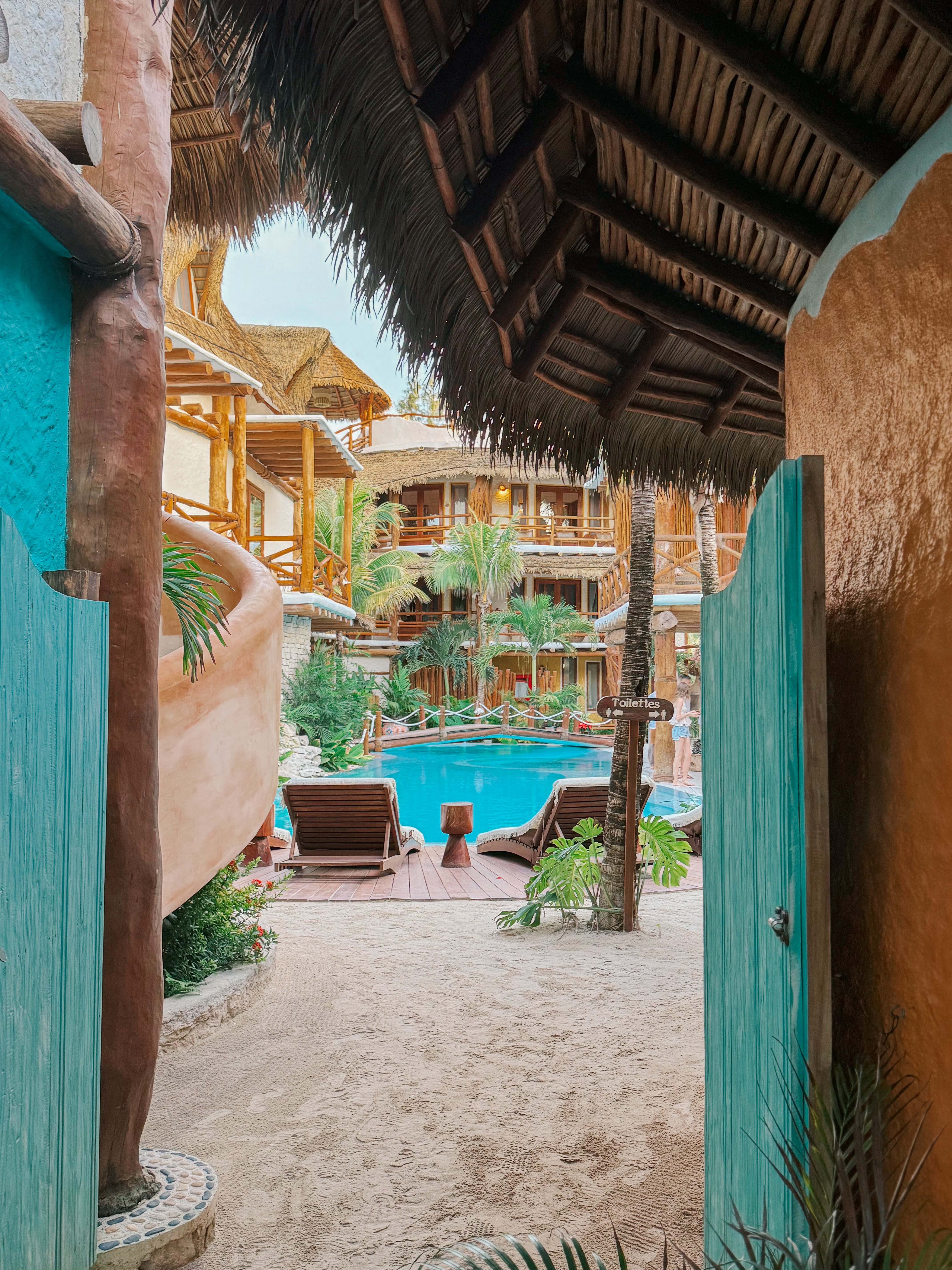Turquoise doors opening toward the pool at Casa Las Tortugas