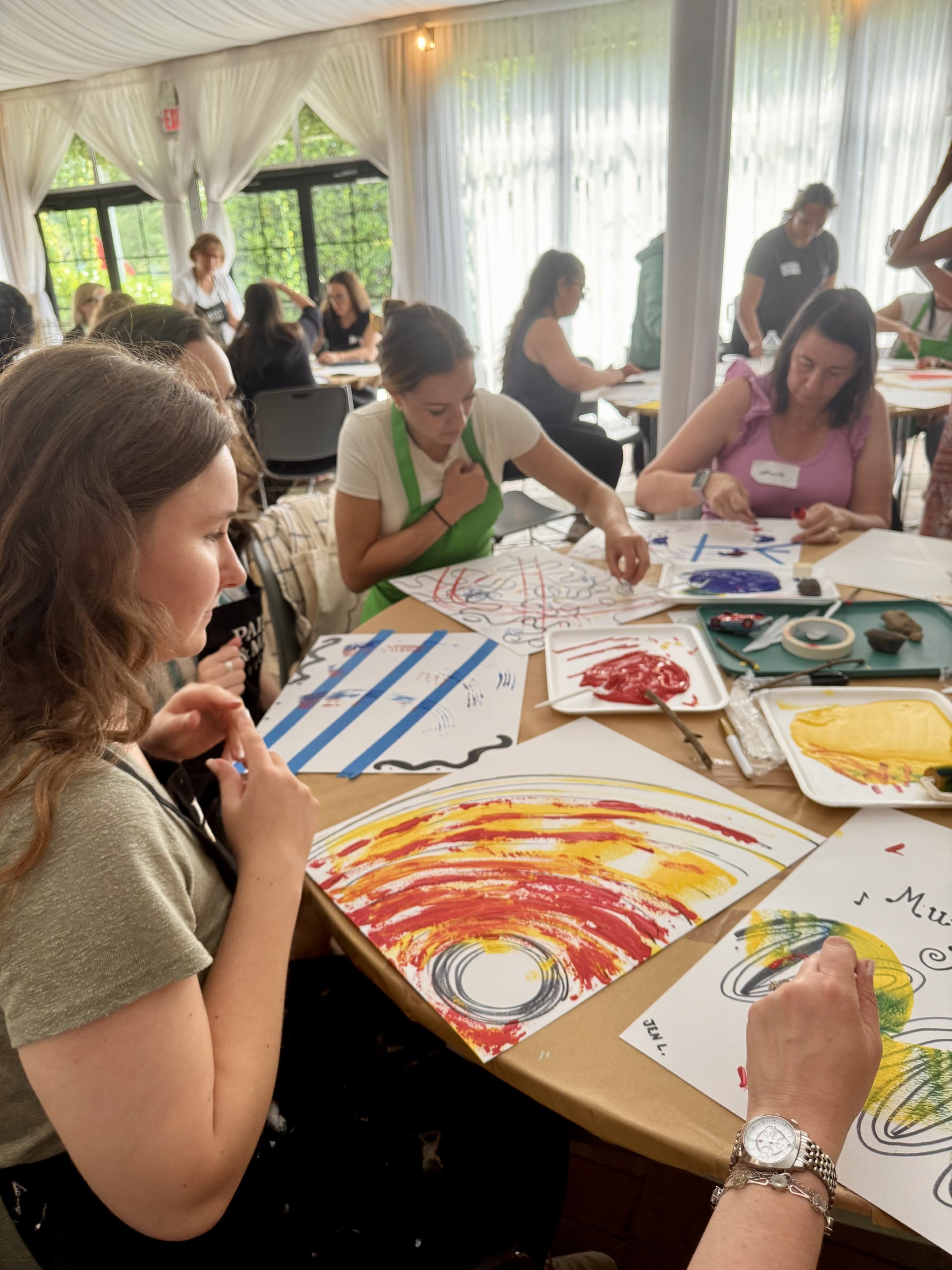Adults creating paintings in the museum’s Educator Day promotional photo