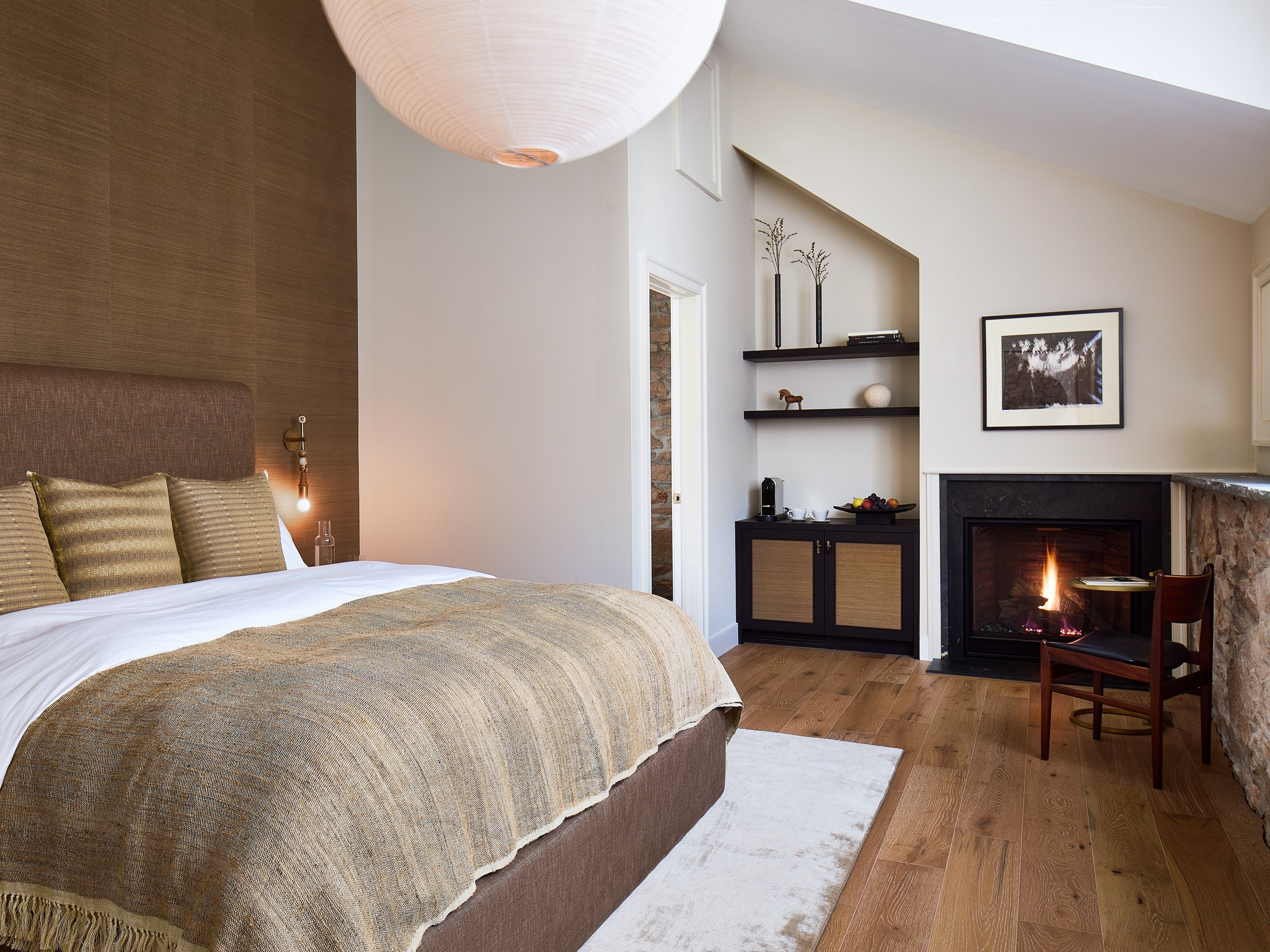Stockton Inn guest room with a fireplace and king-size bed