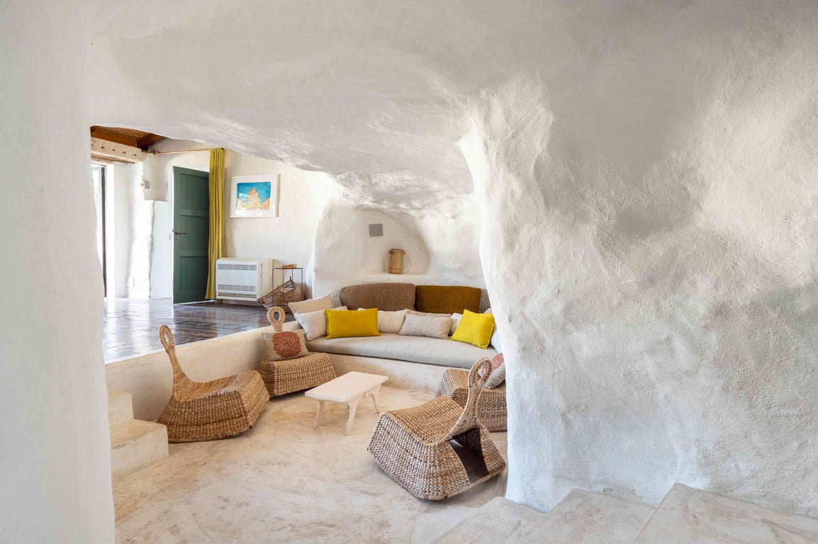 Stone-walled lounge with yellow cushions at Casa Talia