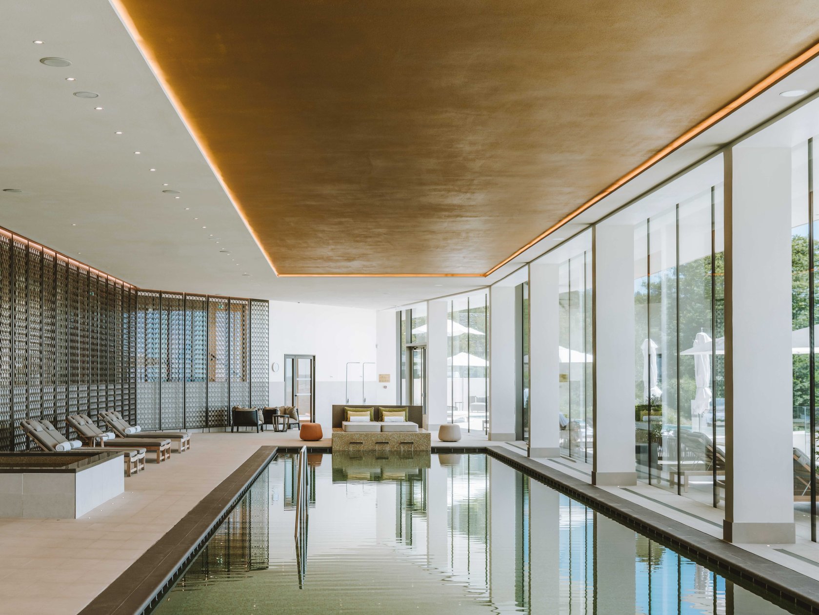 Glass-walled indoor swimming pool at Royal Champagne Hotel + Spa