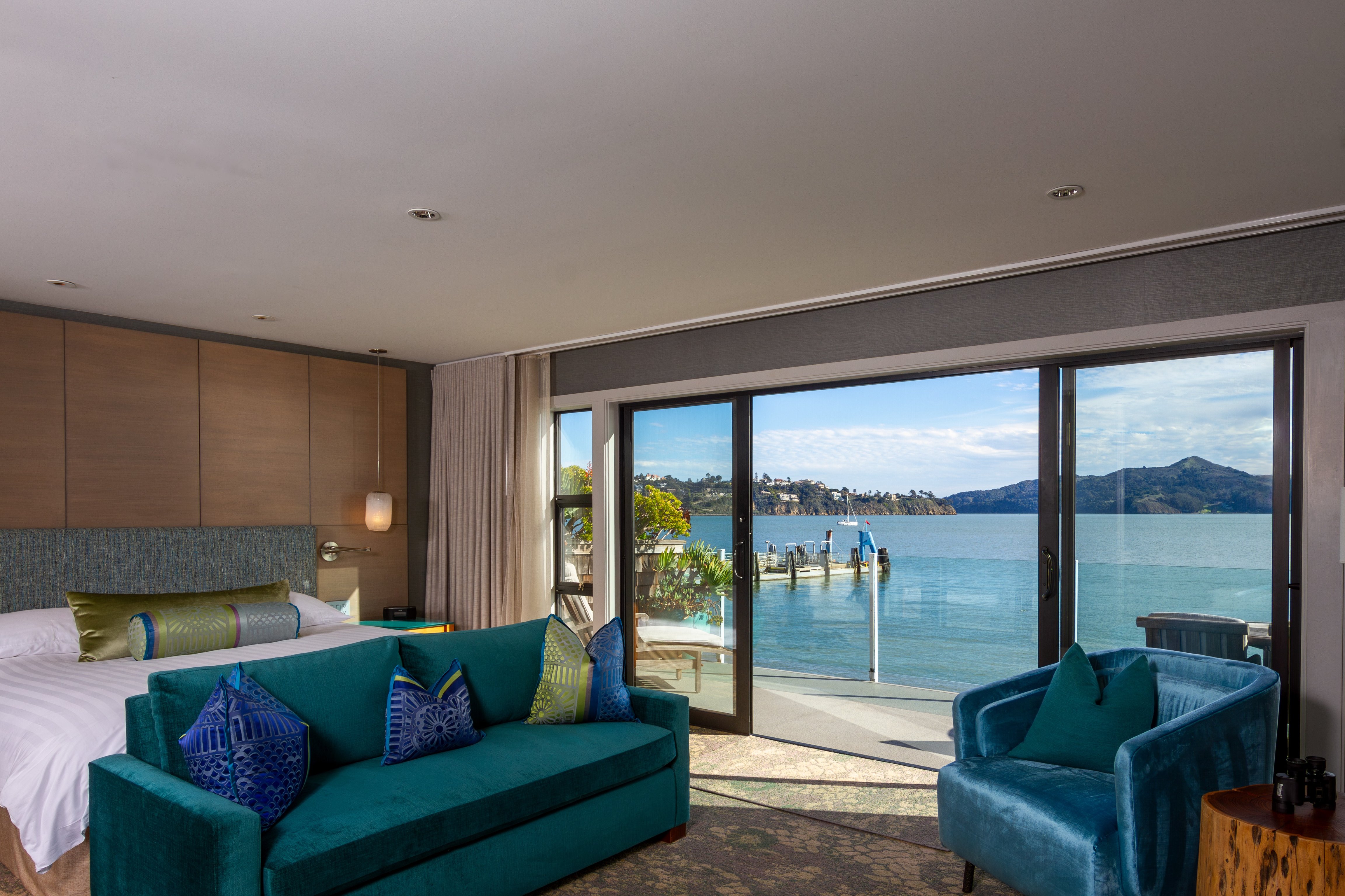 Blue seating and bayfront windows in a suite at The Inn Above Tide