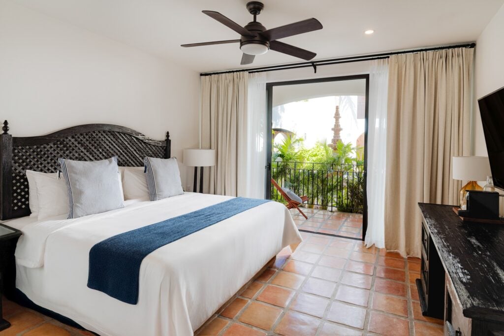 Tropicana Los Cabos guest room with terracotta floors and a balcony