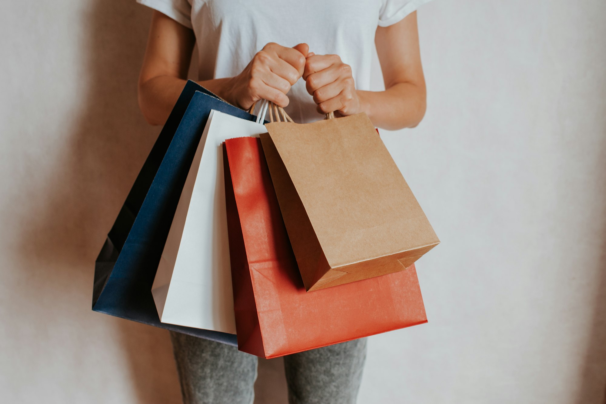 Person holding colorful shopping bags