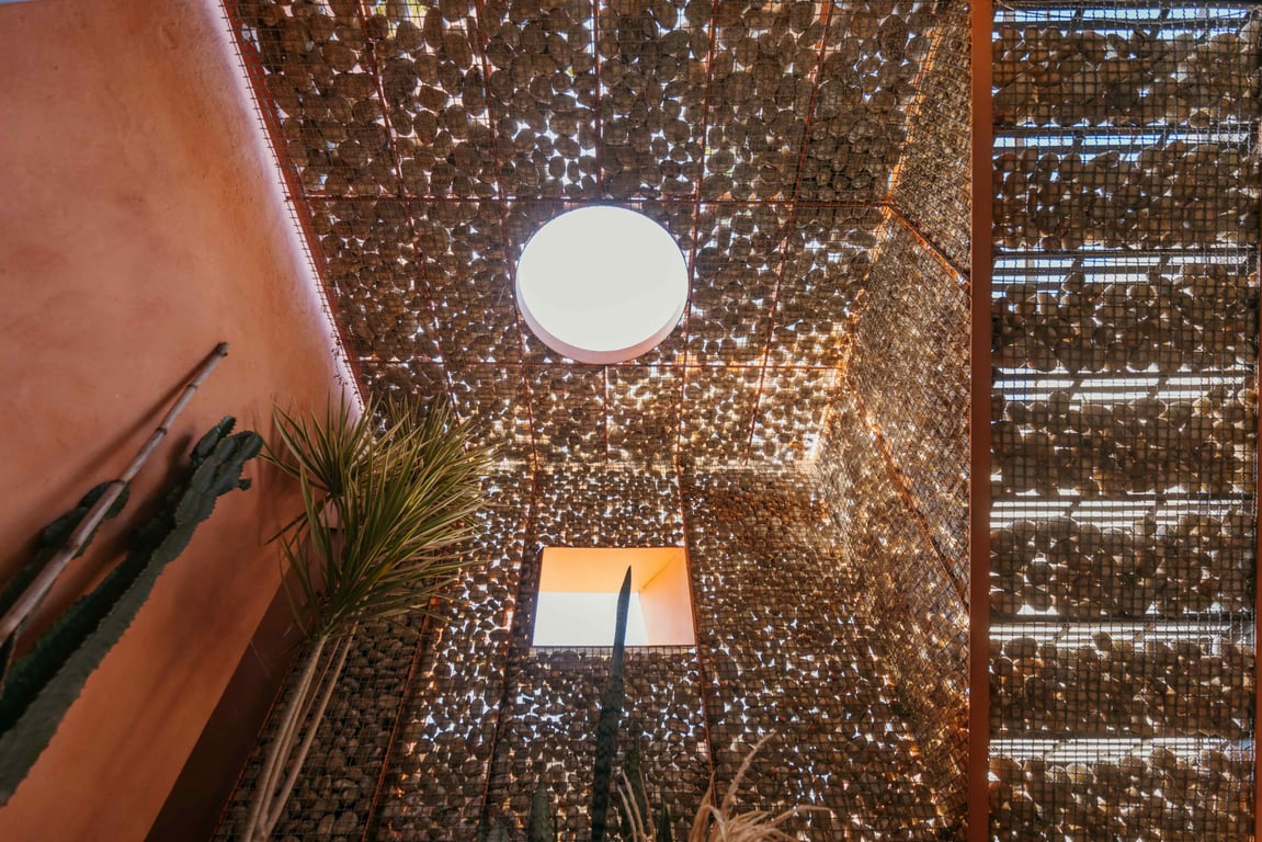 Perforated metal screen and staircase casting patterned light